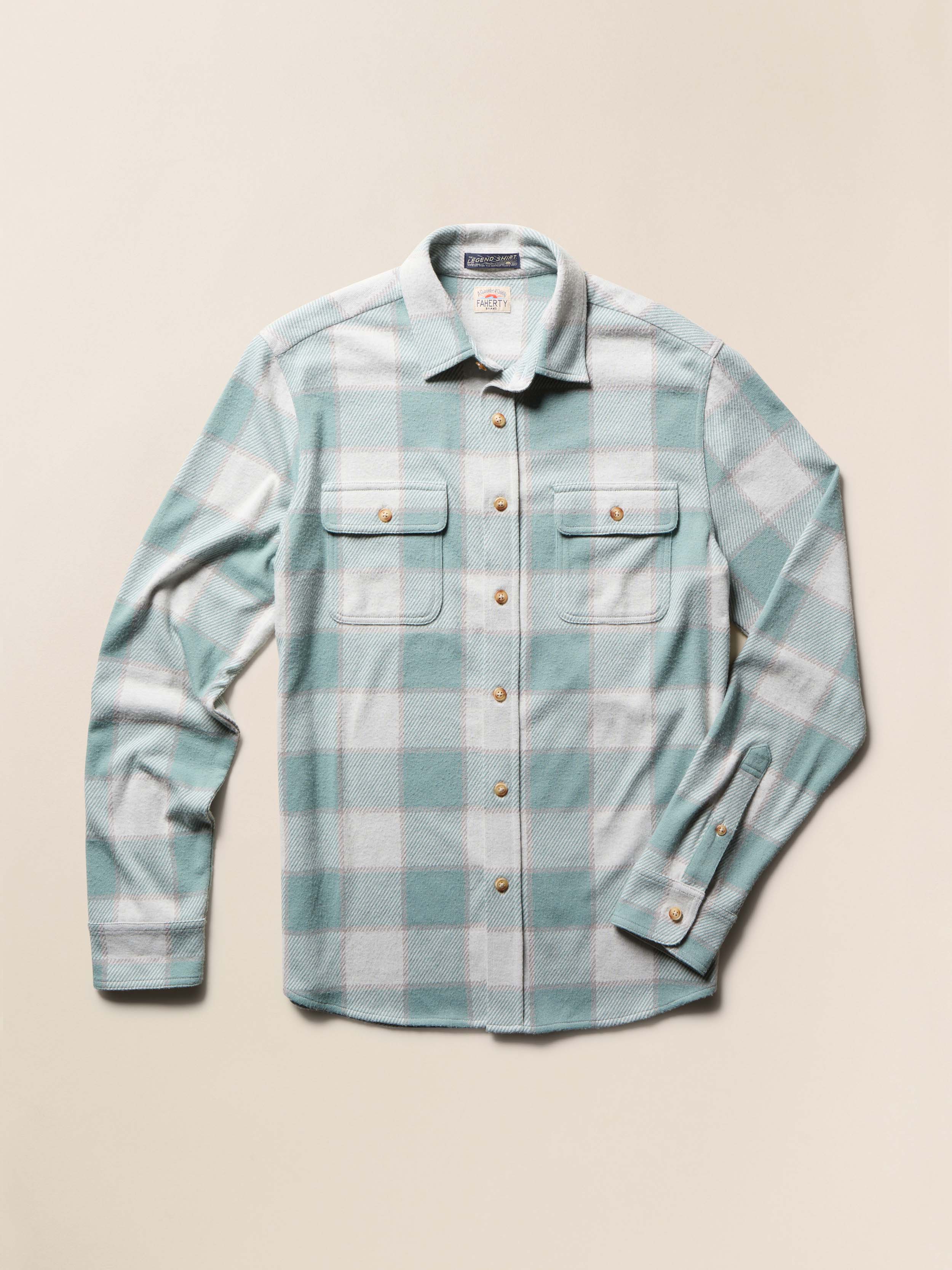 Green and white plaid long sleeve shirt on a beige background