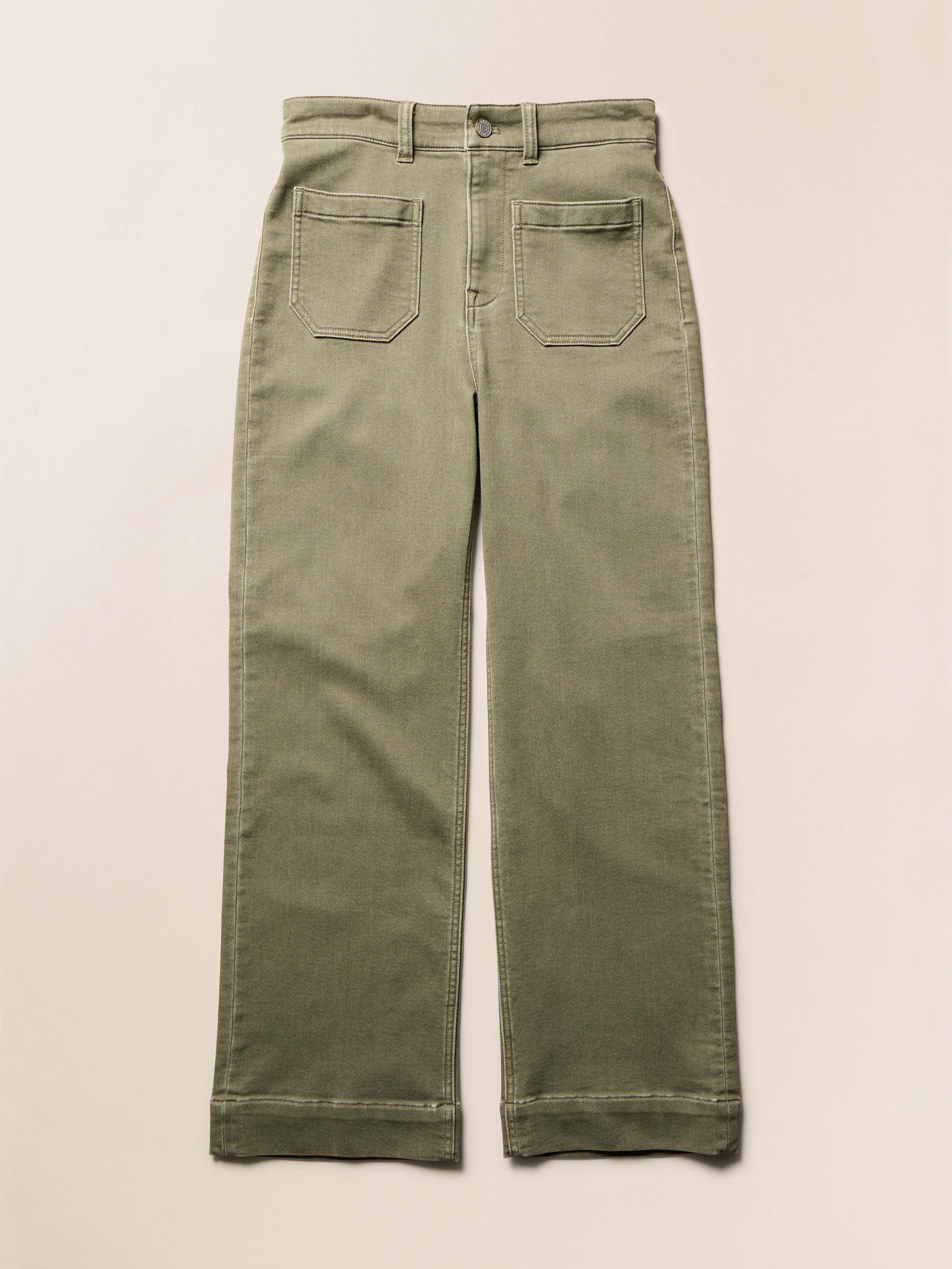 Olive green stretch terry pants on a beige background