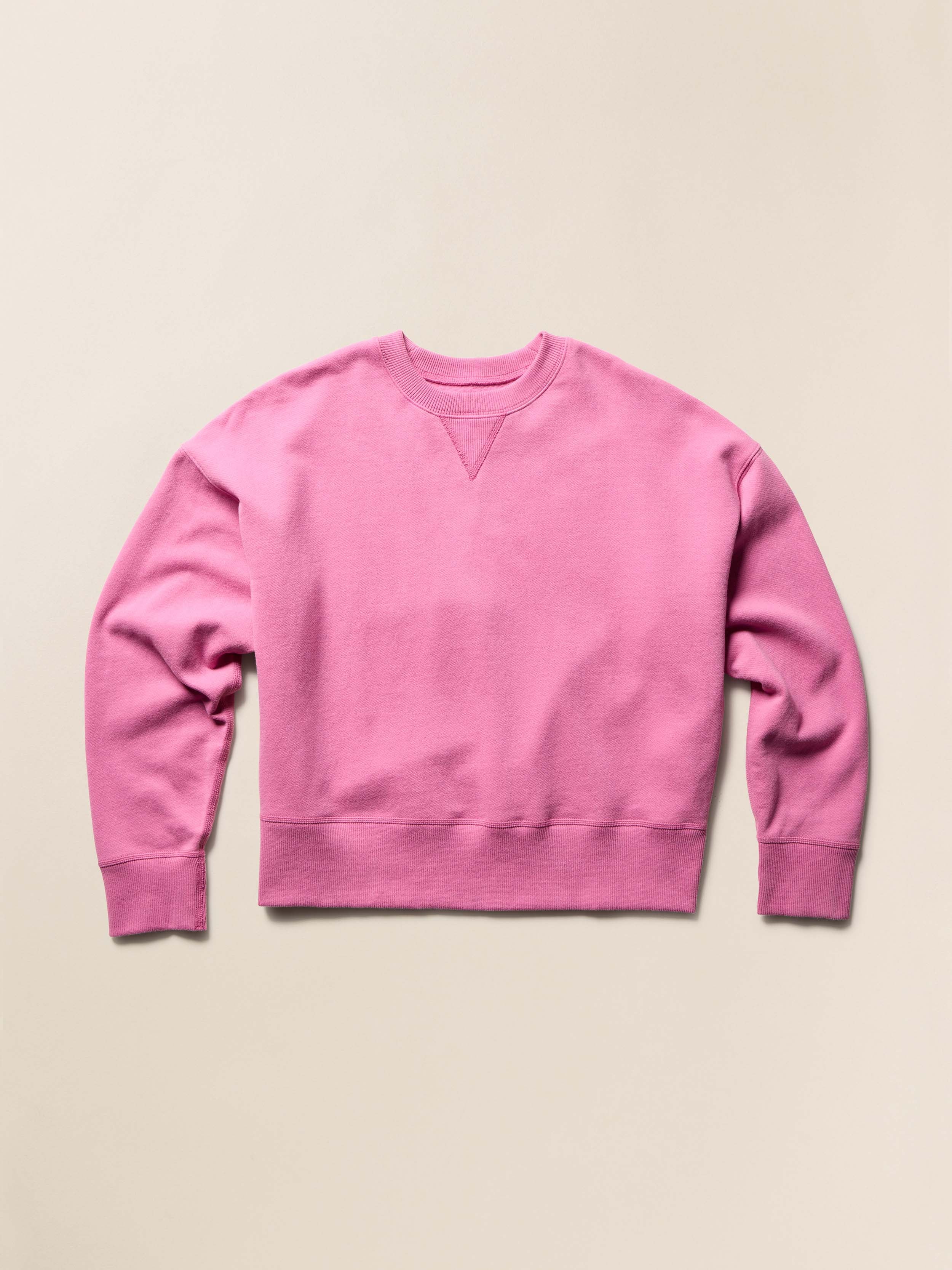 Pink crewneck sweatshirt on a beige background