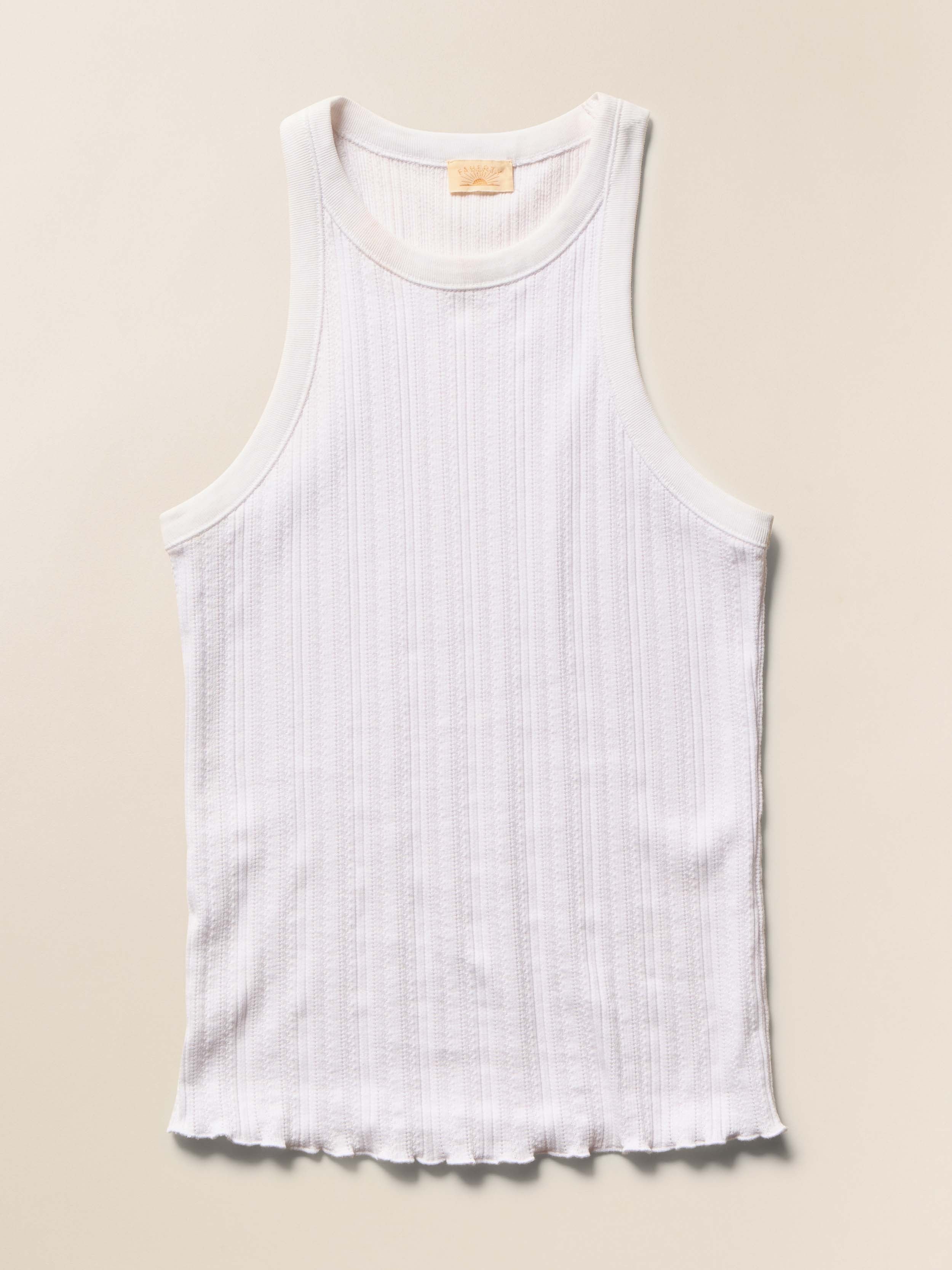 White pointelle tank top against a beige background