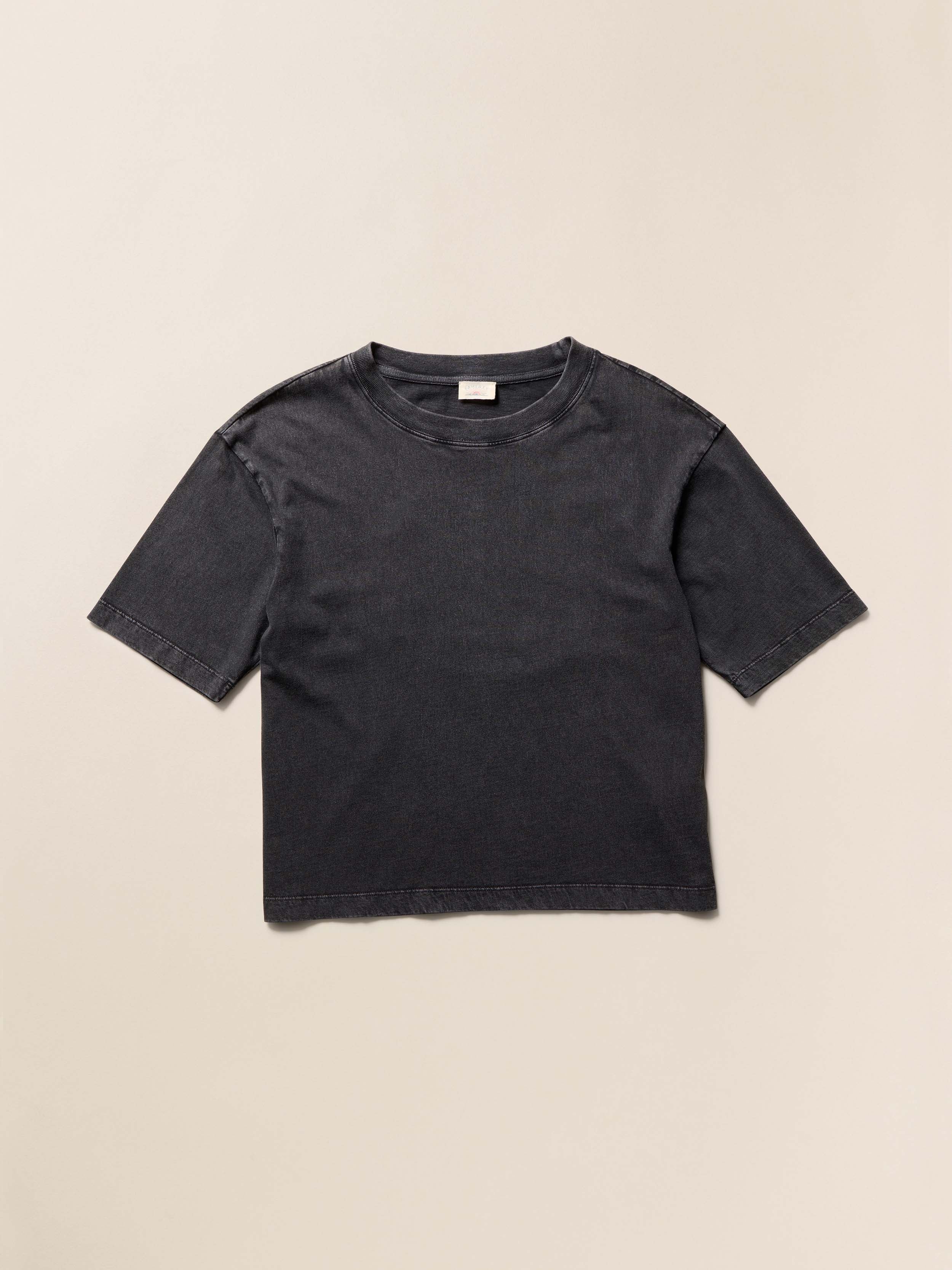 Black cotton t-shirt on a beige background