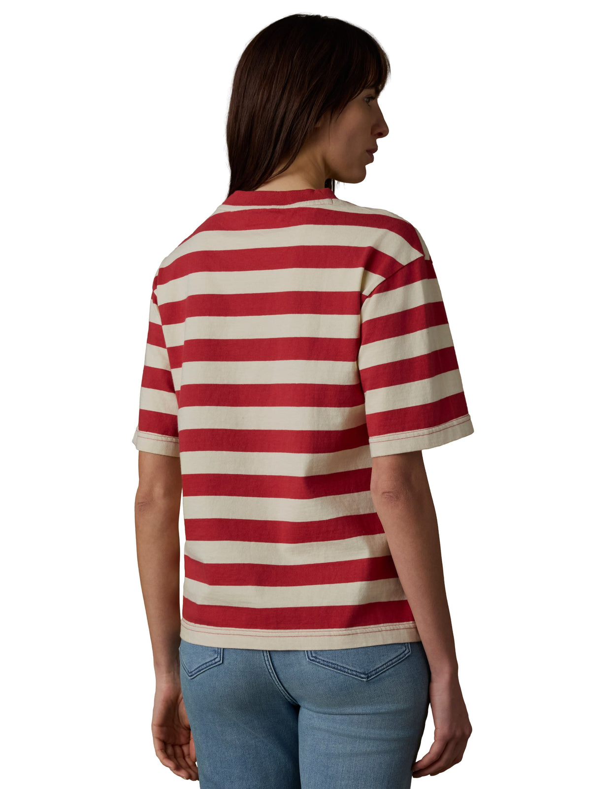 A woman viewed from behind wearing a red and white short sleeve tee and blue jeans, image 3 of 3