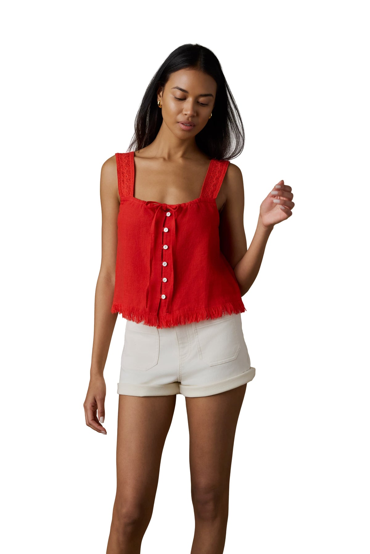 A woman wearing a red tank top and white shorts, image 1 of 5