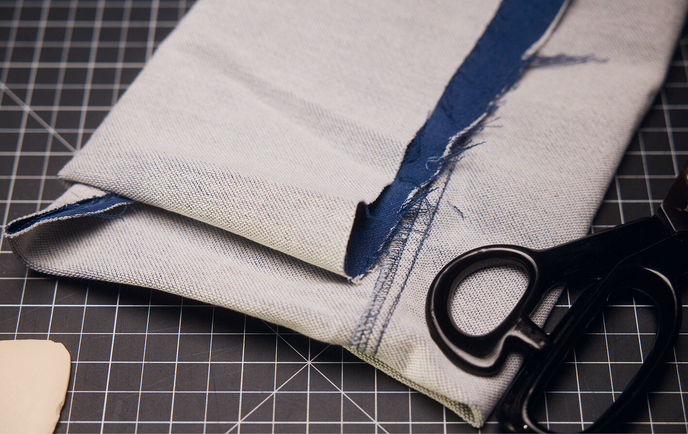 Close up of stretch terry fabric showing construction of material, sitting on a cutting board in a design studio