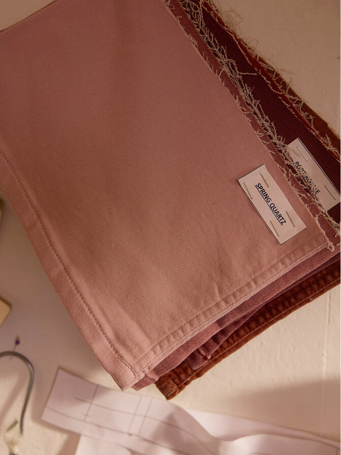 A photo of stretch terry fabric swatches hanging on a design studio moodboard