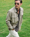 Man walking in a field wearing Movement Flex Linen Shirt jacket and Faherty Sunglasses.