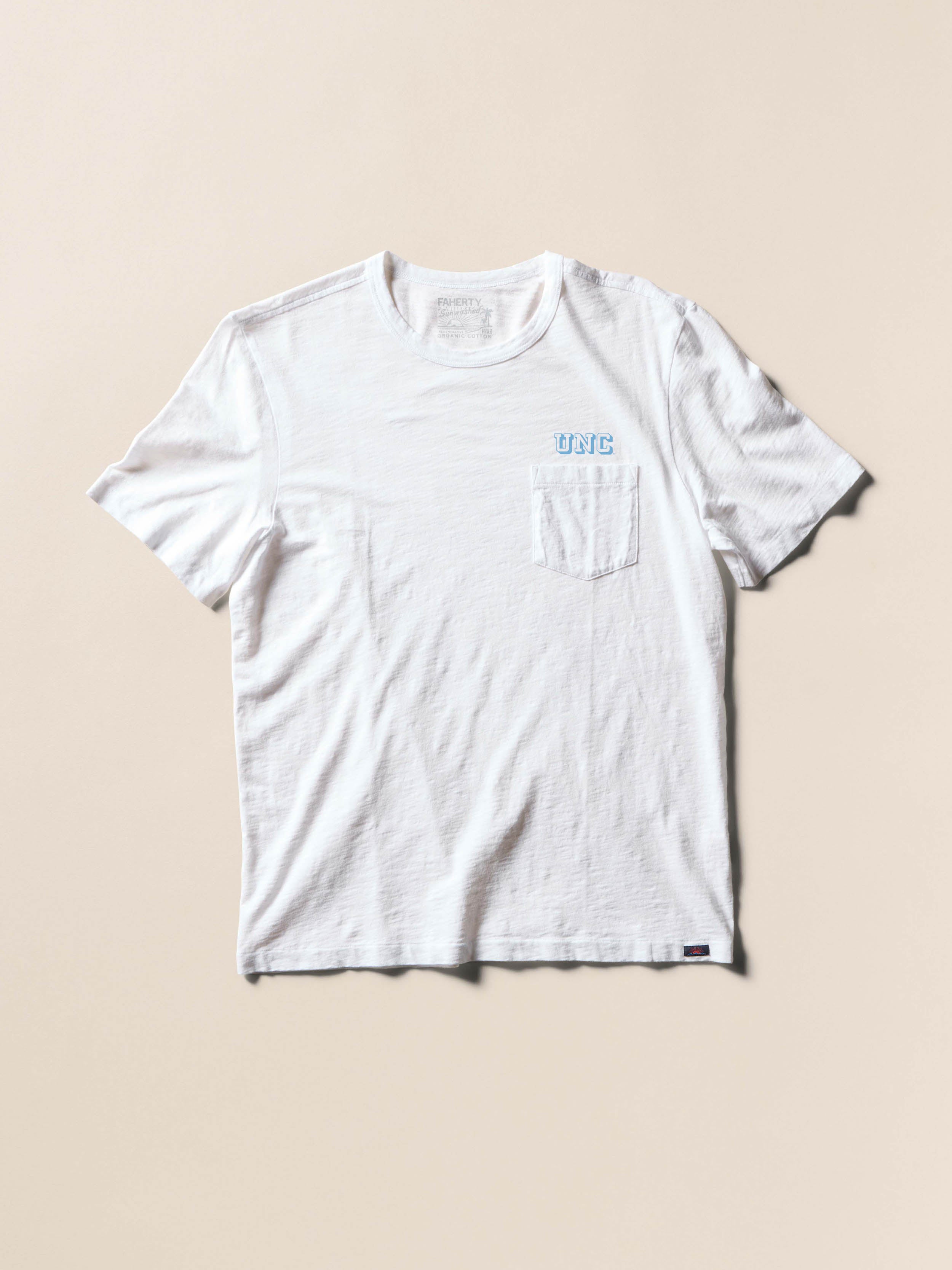 White short sleeve t-shirt with UNC graphic at the front chest and the back against a beige background