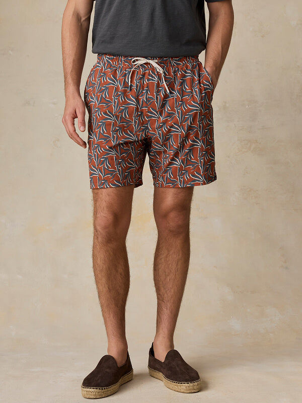 Close up of model wearing patterned shorelite trunks 