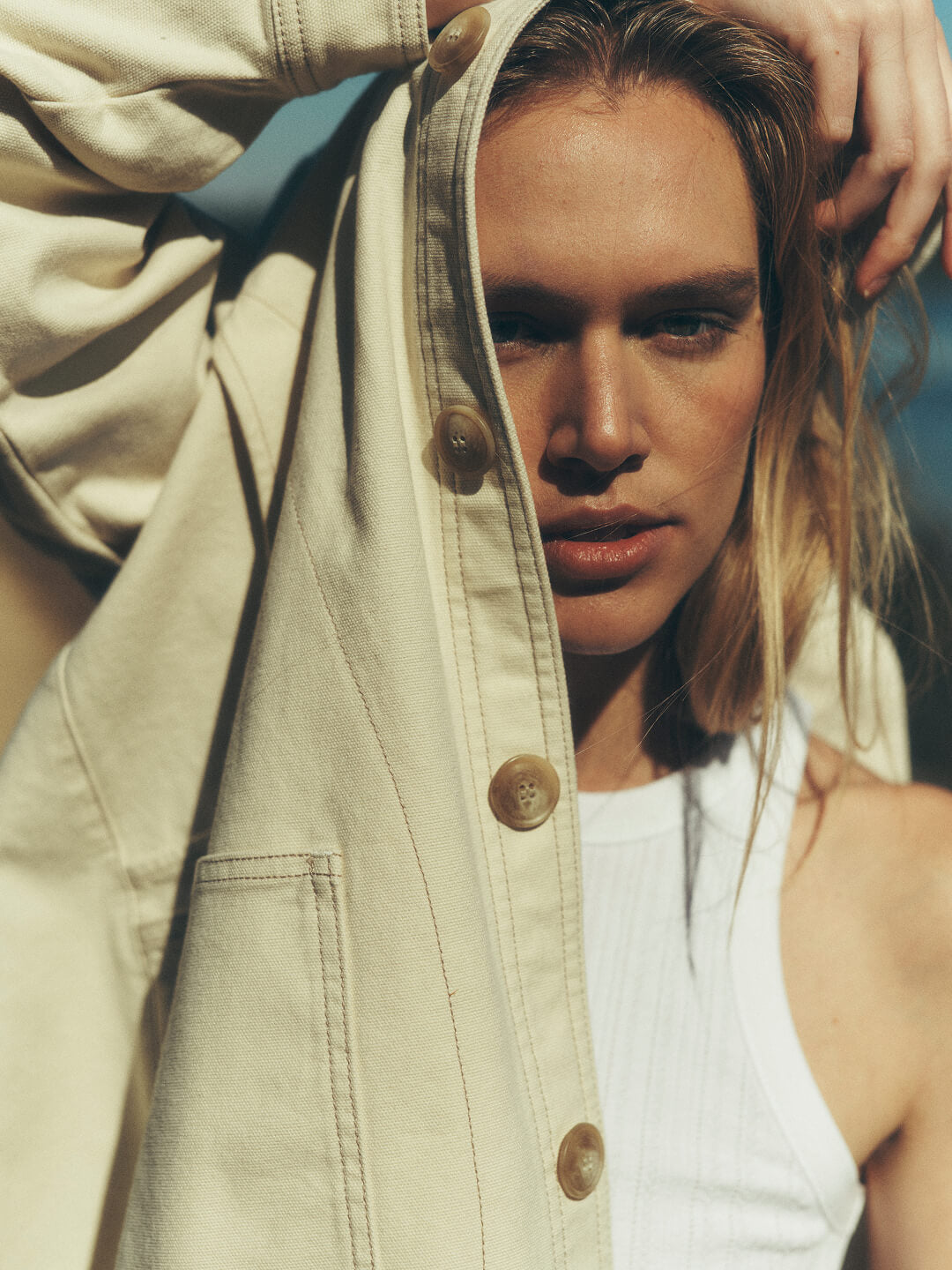 Female model on a low country bay wearing a sunwashed canvas barn jacket.