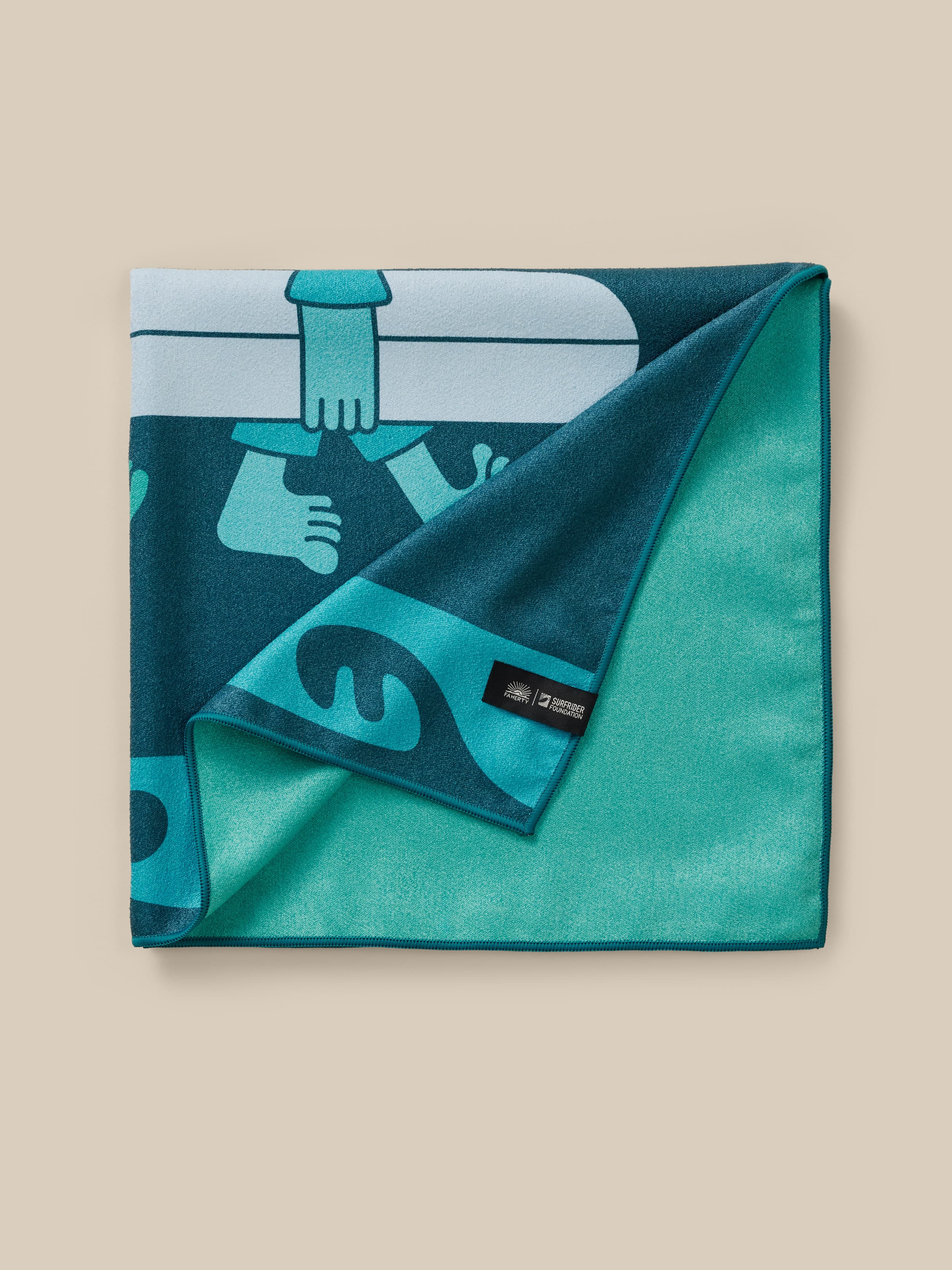 Teal towel with graphic design on a beige background