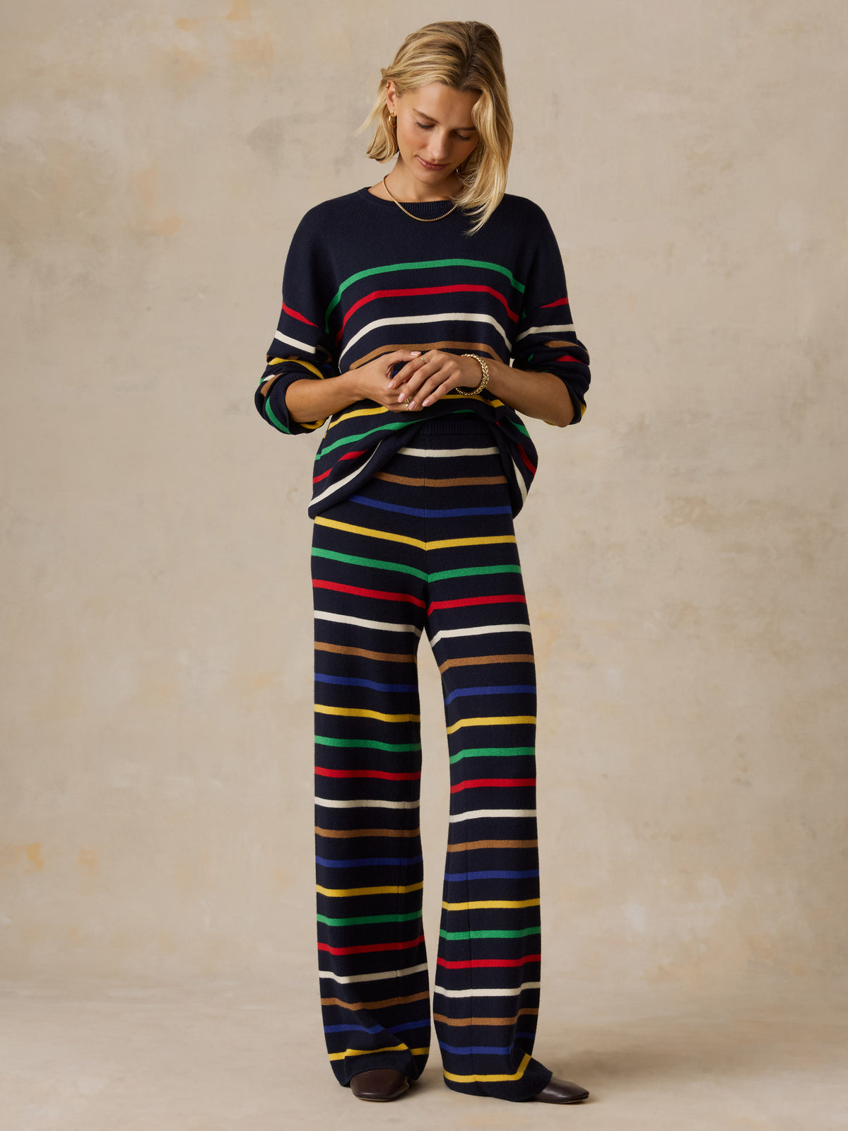 A woman wearing a striped set, image 5 of 6