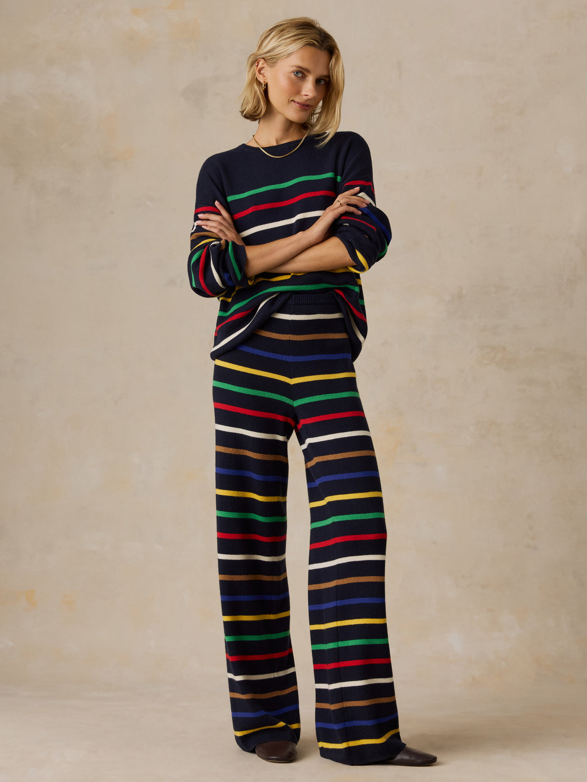 A woman wearing a striped set, image 2 of 6