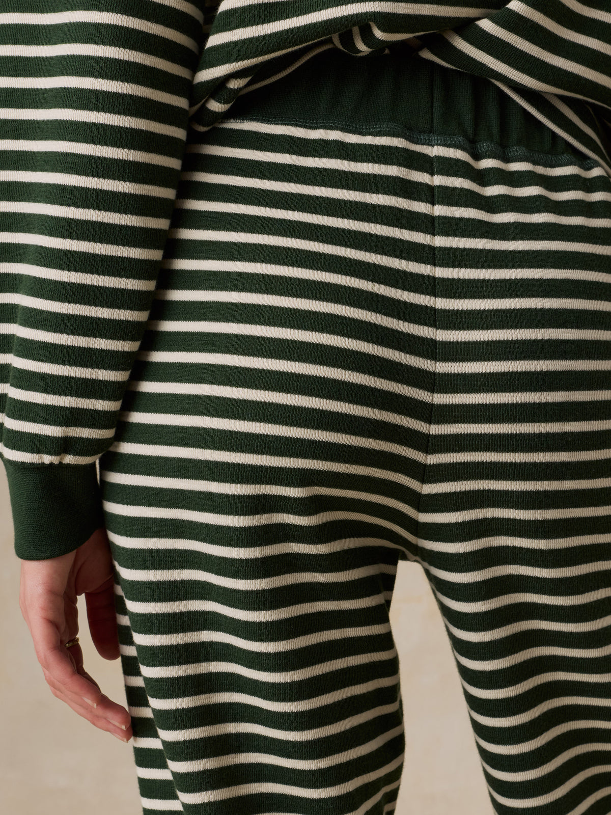 Close up of a woman viewed from behind wearing a green striped pajama Set, image 6 of 6