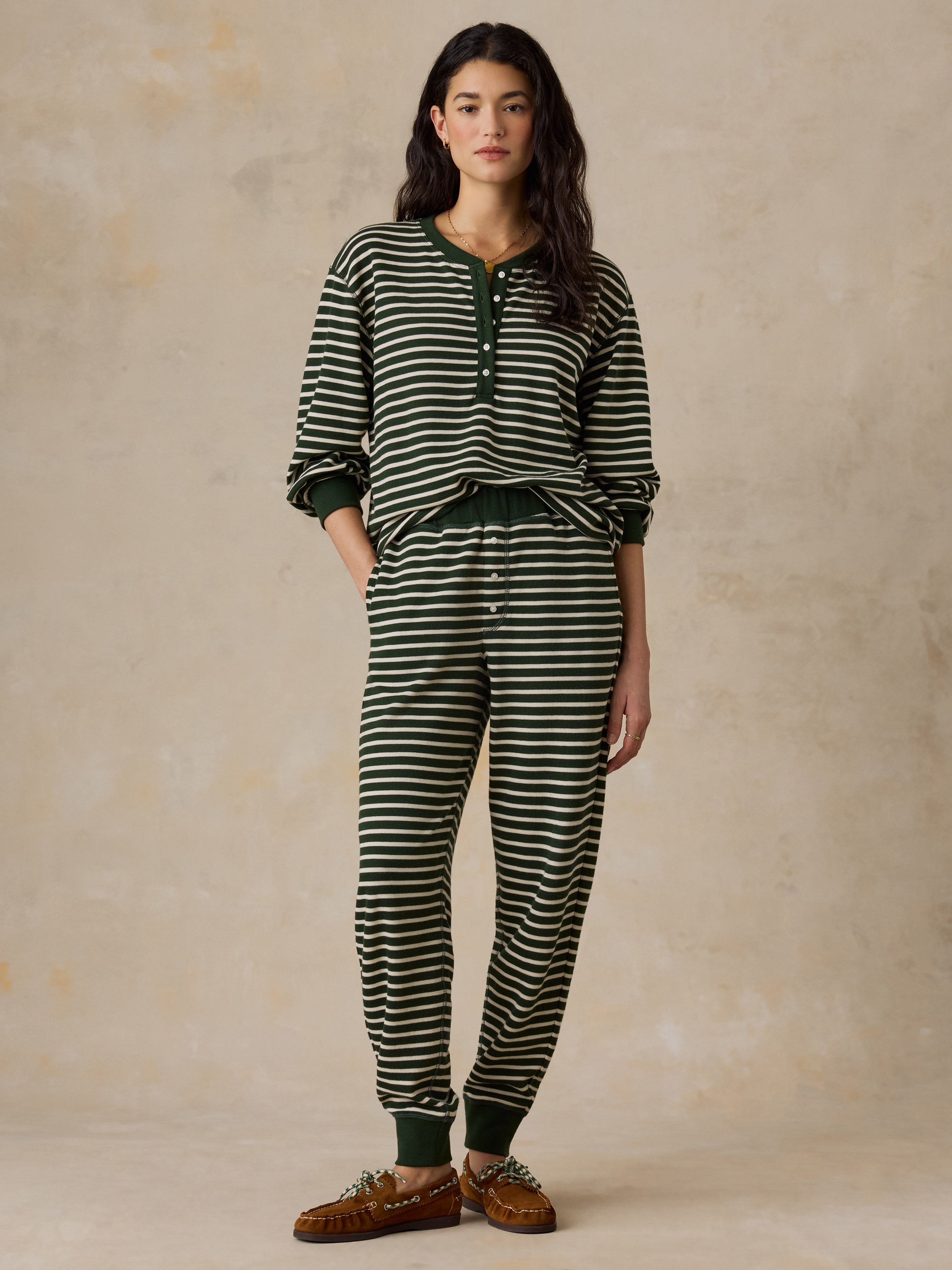 A woman wearing a green striped pajama set