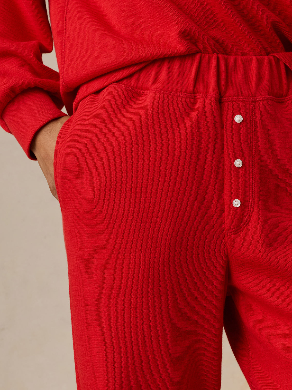 Close up of a woman wearing a red pajama set, image 5 of 5