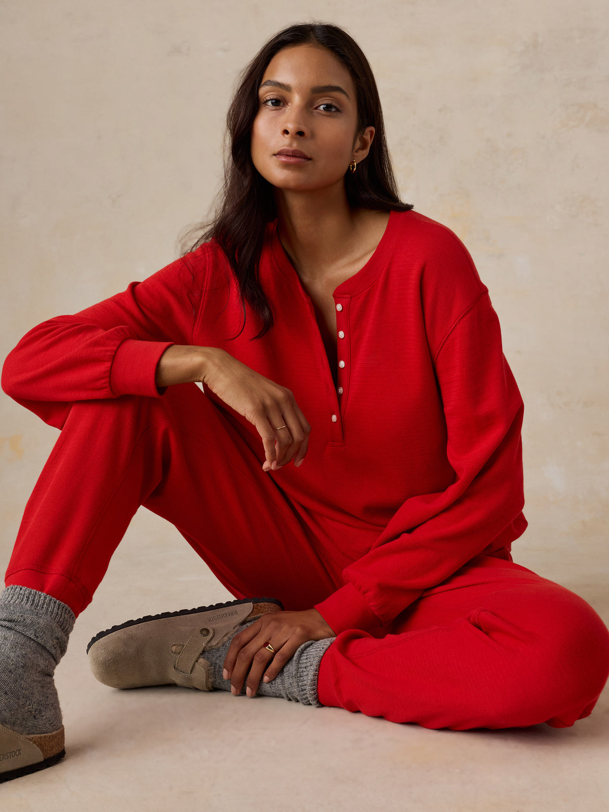 A woman wearing a red pajama set, image 3 of 5