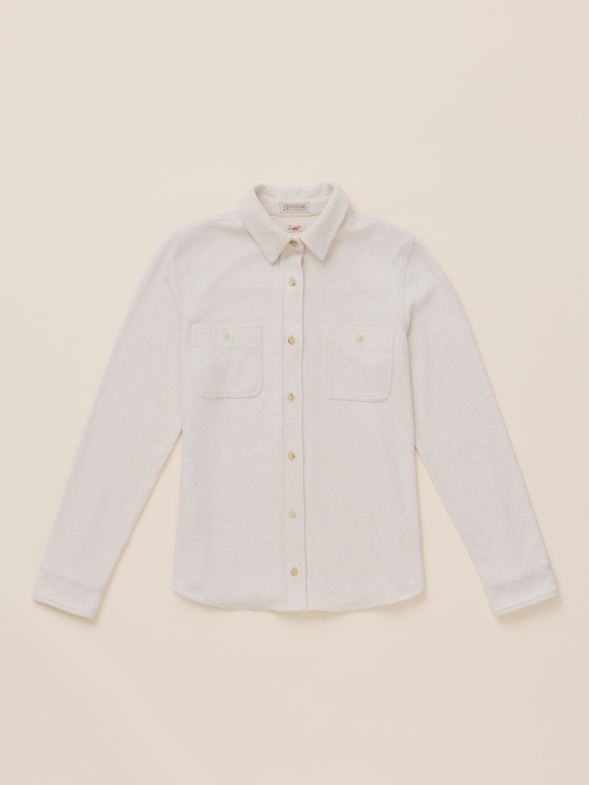 An off white long-sleeve button-up shirt with two chest pockets, laid flat on a matching light beige background., image 6 of 7