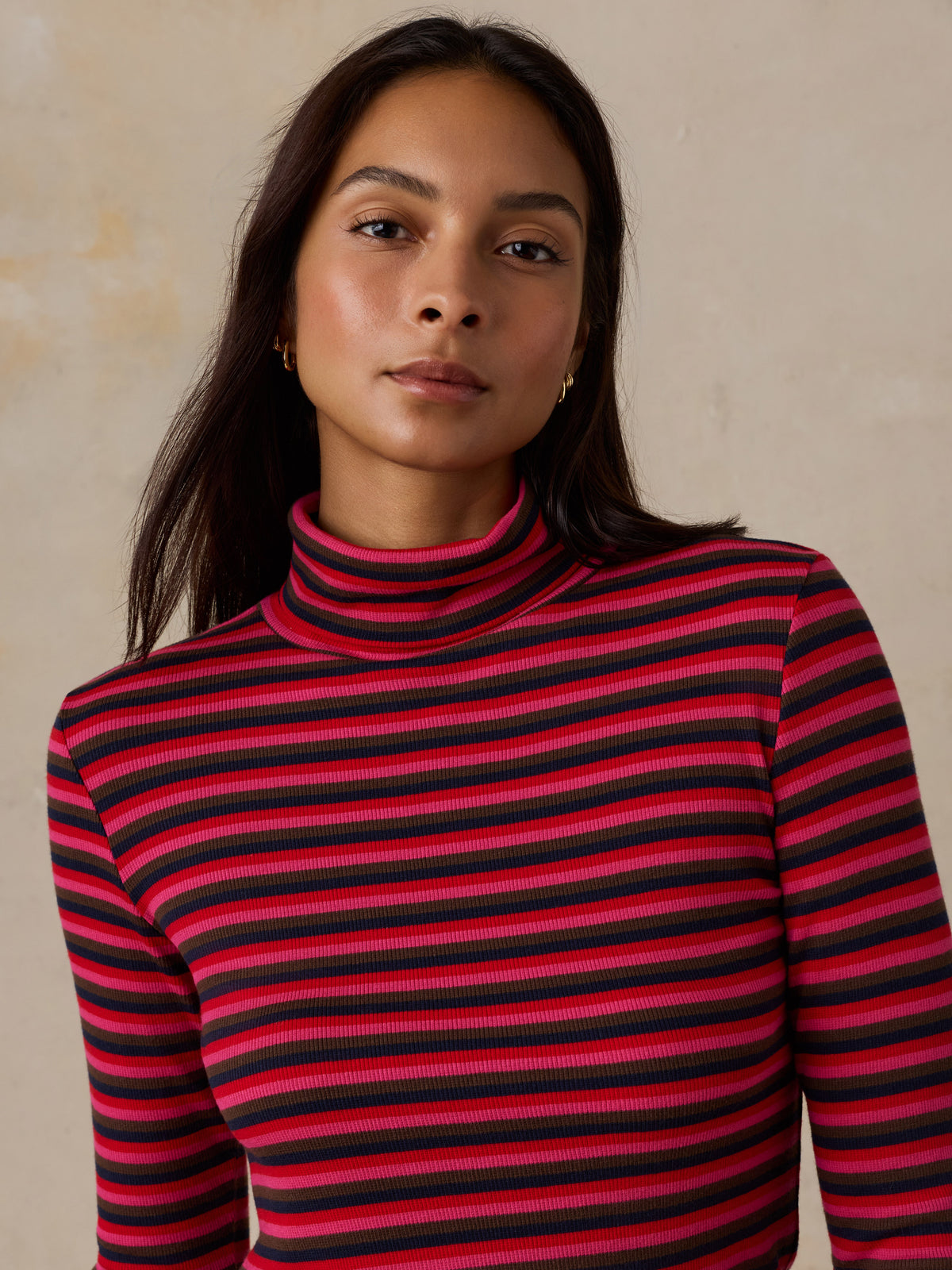 Close up of a woman wearing a striped turtleneck, image 6 of 6