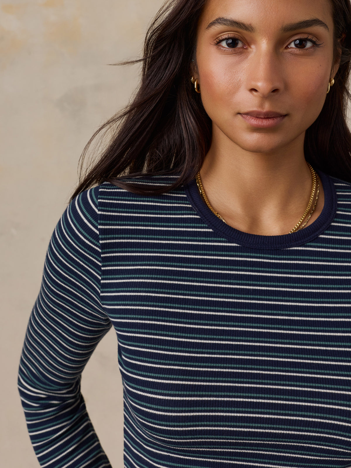 Close up of a woman wearing a blue striped shirt, image 3 of 6