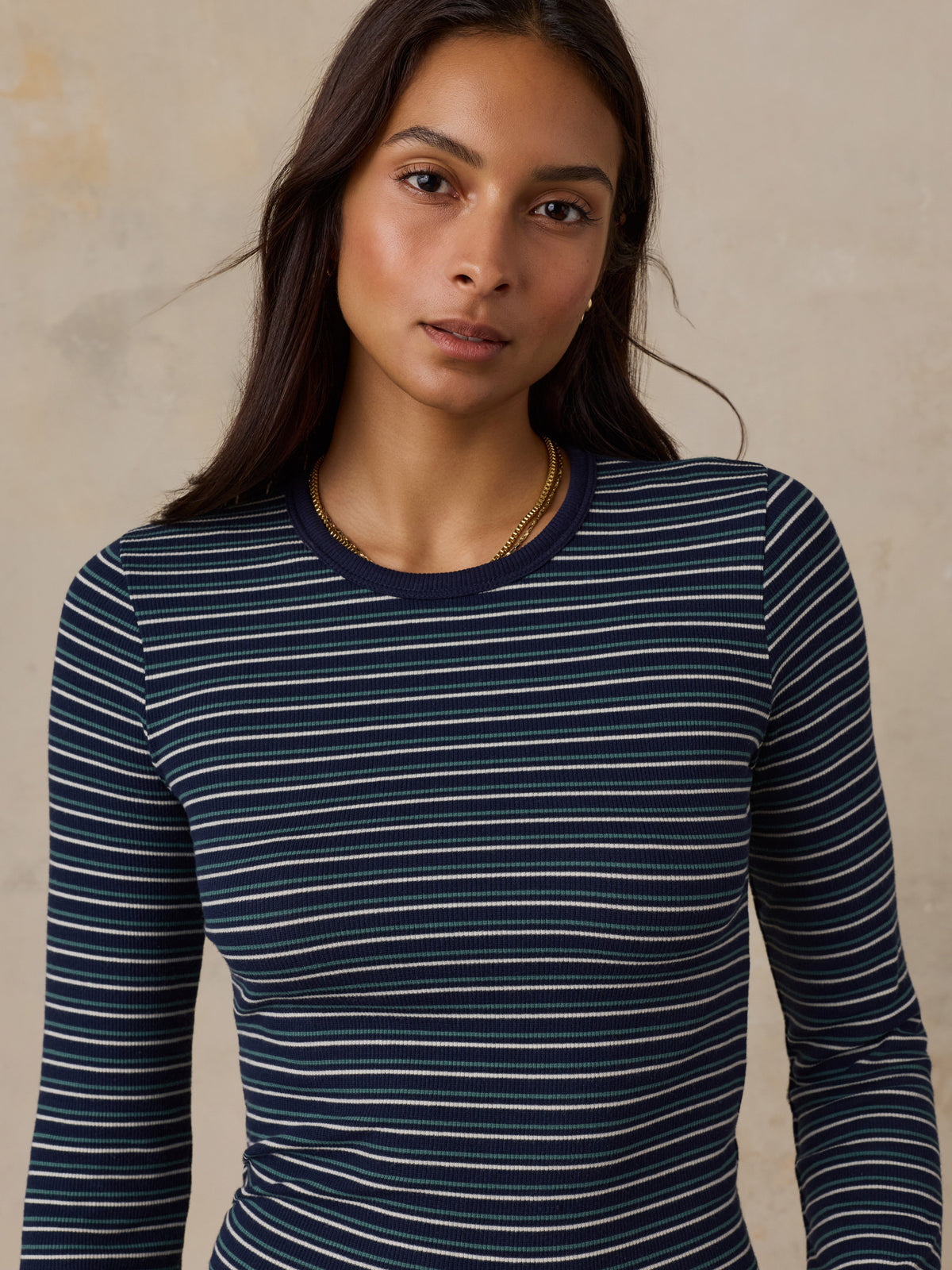 Close up of a woman wearing a blue striped shirt, image 6 of 6