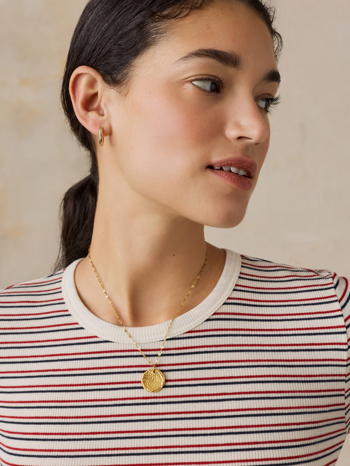 Close up of a woman wearing a striped shirt , image 6 of 6