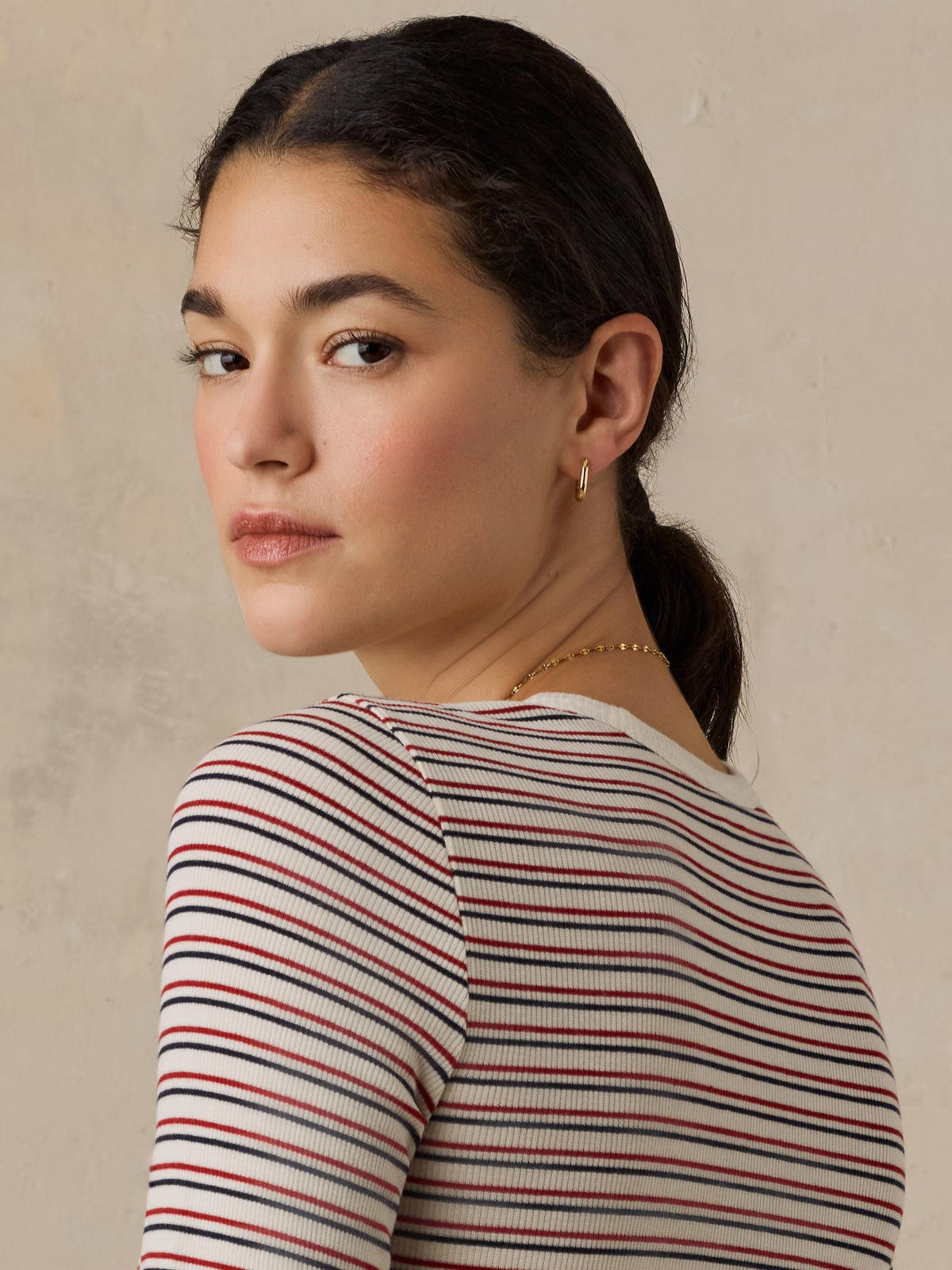 Close up of a woman wearing a striped shirt, image 3 of 6