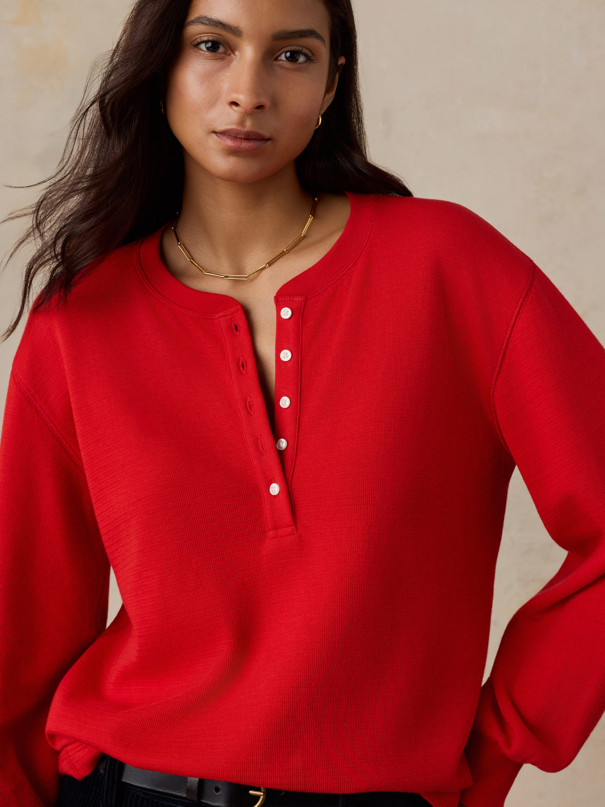 Close up of a woman wearing a red henley, image 3 of 5
