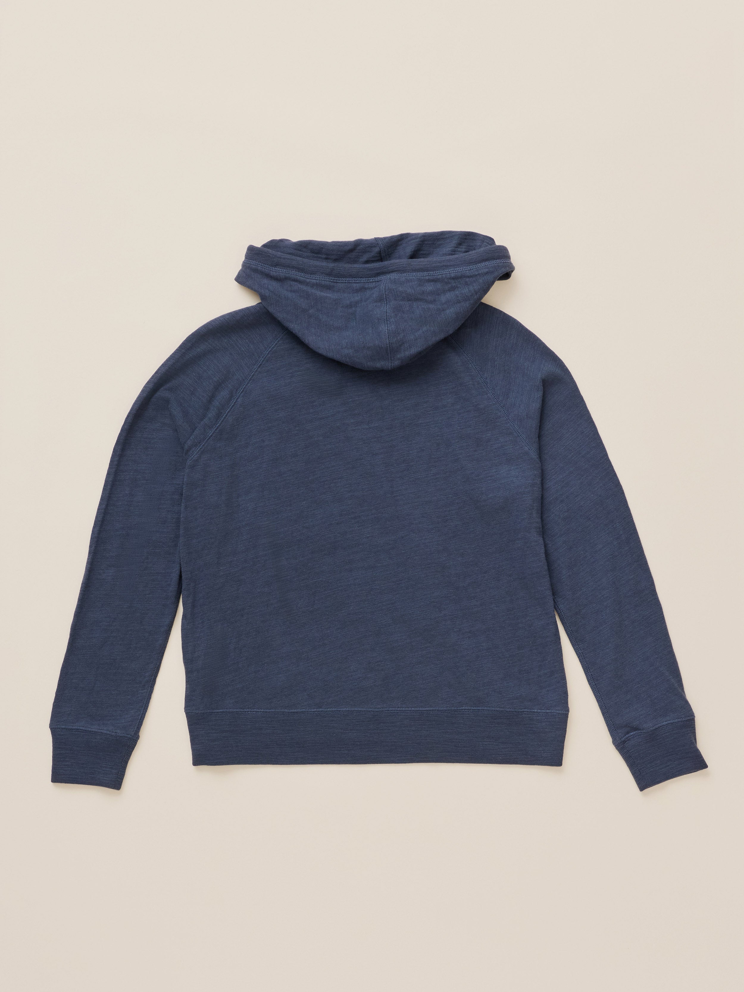A navy blue hooded sweatshirt shown from the back, laid flat on a light beige background.