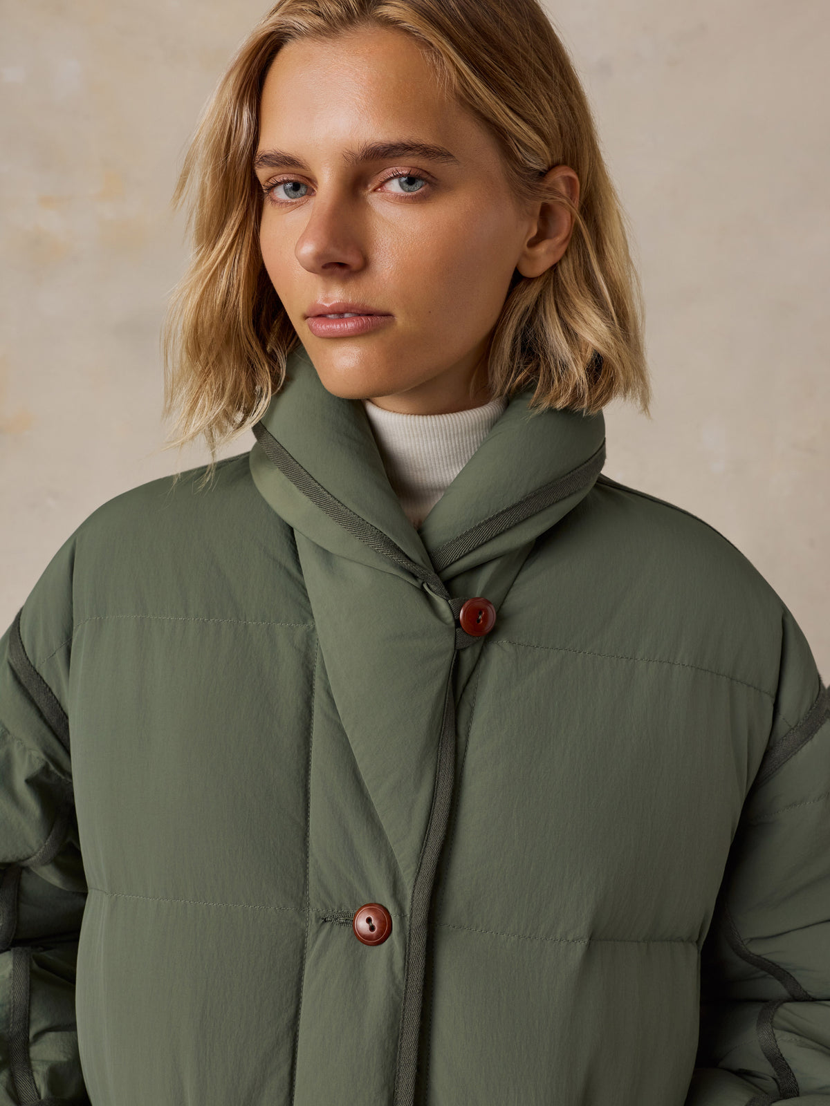 Close up of a woman wearing a green jacket , image 4 of 7