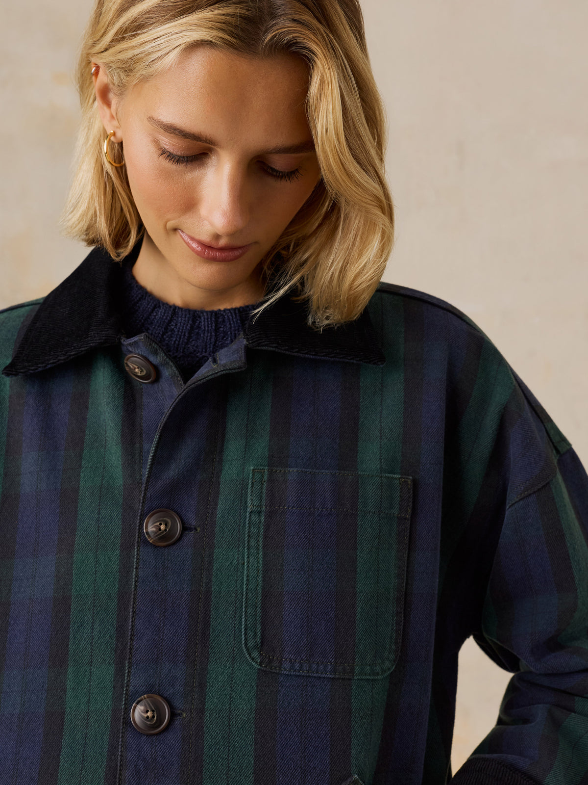 Close up of a woman wearing a green plaid jacket , image 3 of 6