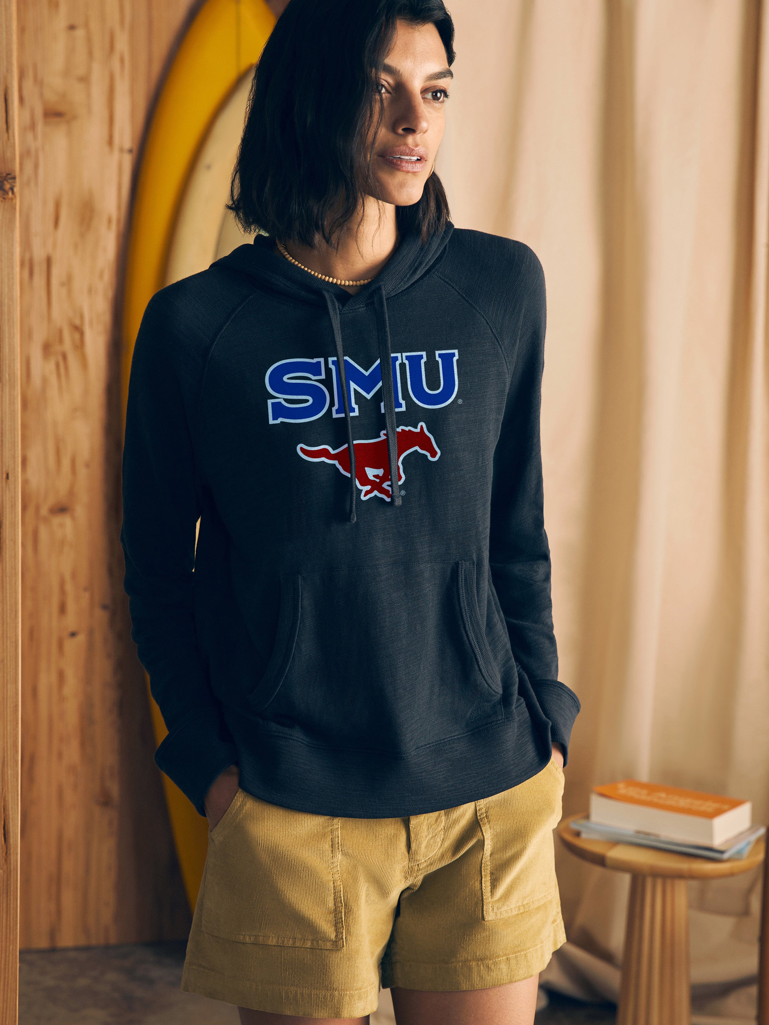 Woman wearing a navy hoodie with SMU graphic logo at the center chest