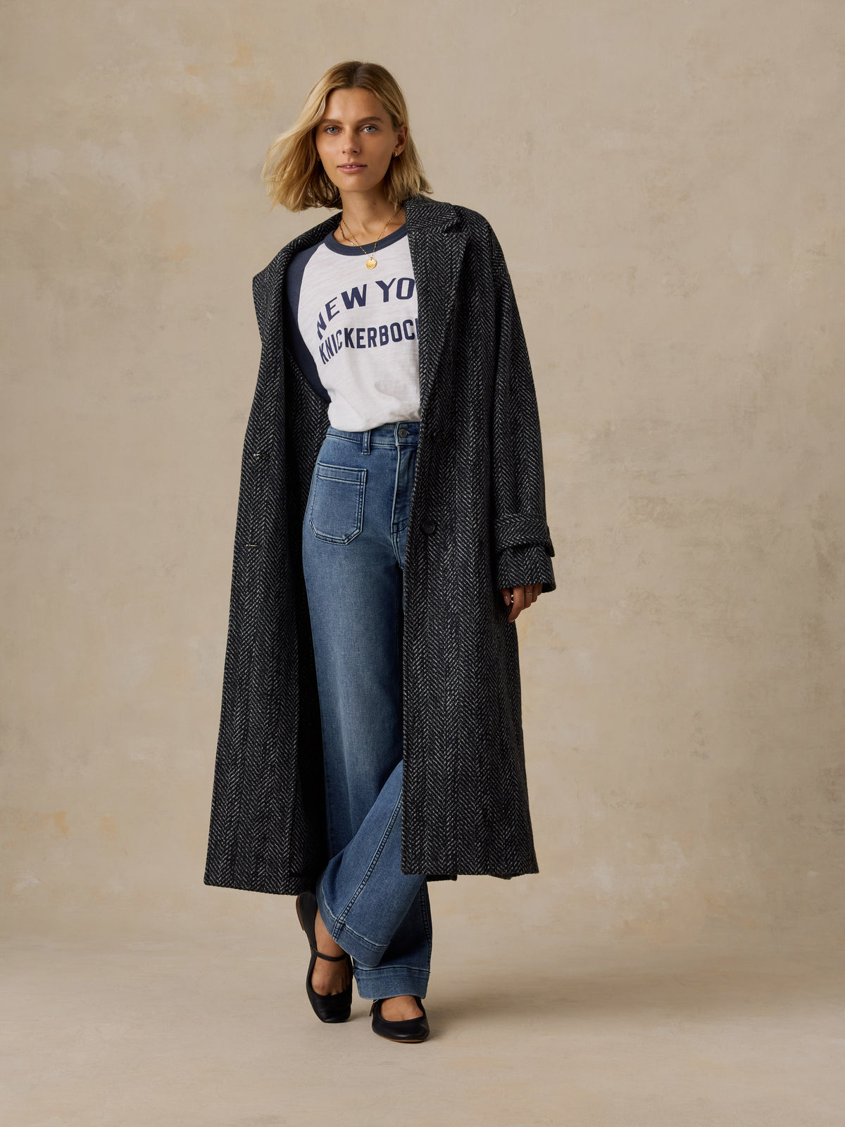 A woman wearing a blue and white NY Knicks baseball tee , image 6 of 6
