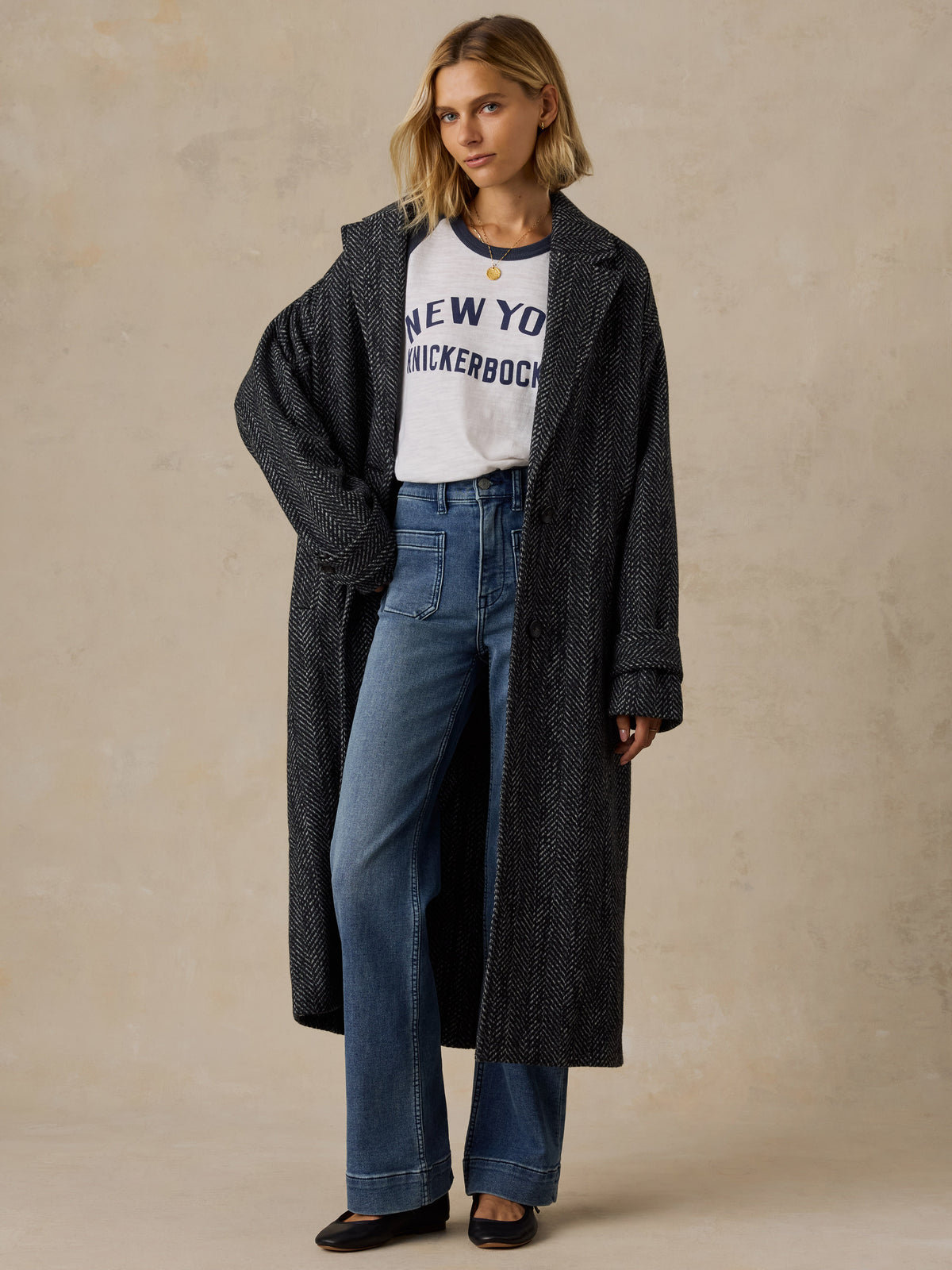 A woman wearing a blue and white NY Knicks baseball tee, image 3 of 6