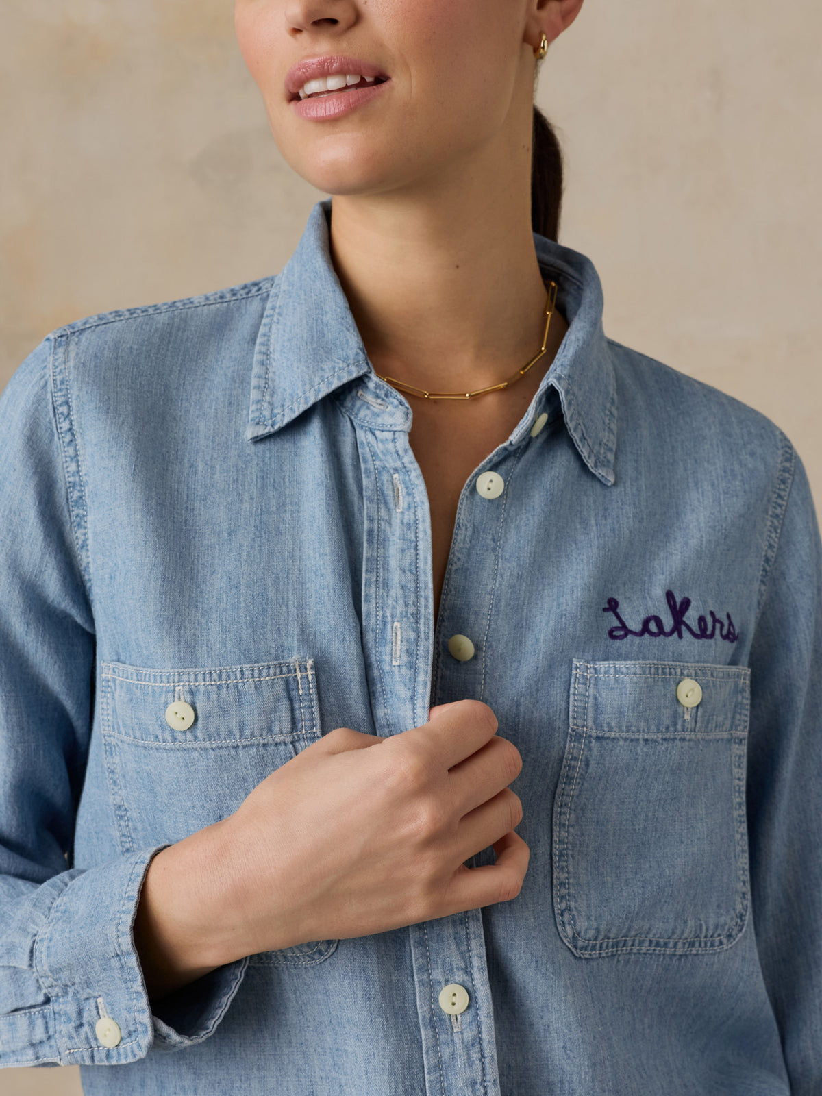 Close up of a woman wearing a LA Lakers chambray shirt, image 4 of 6