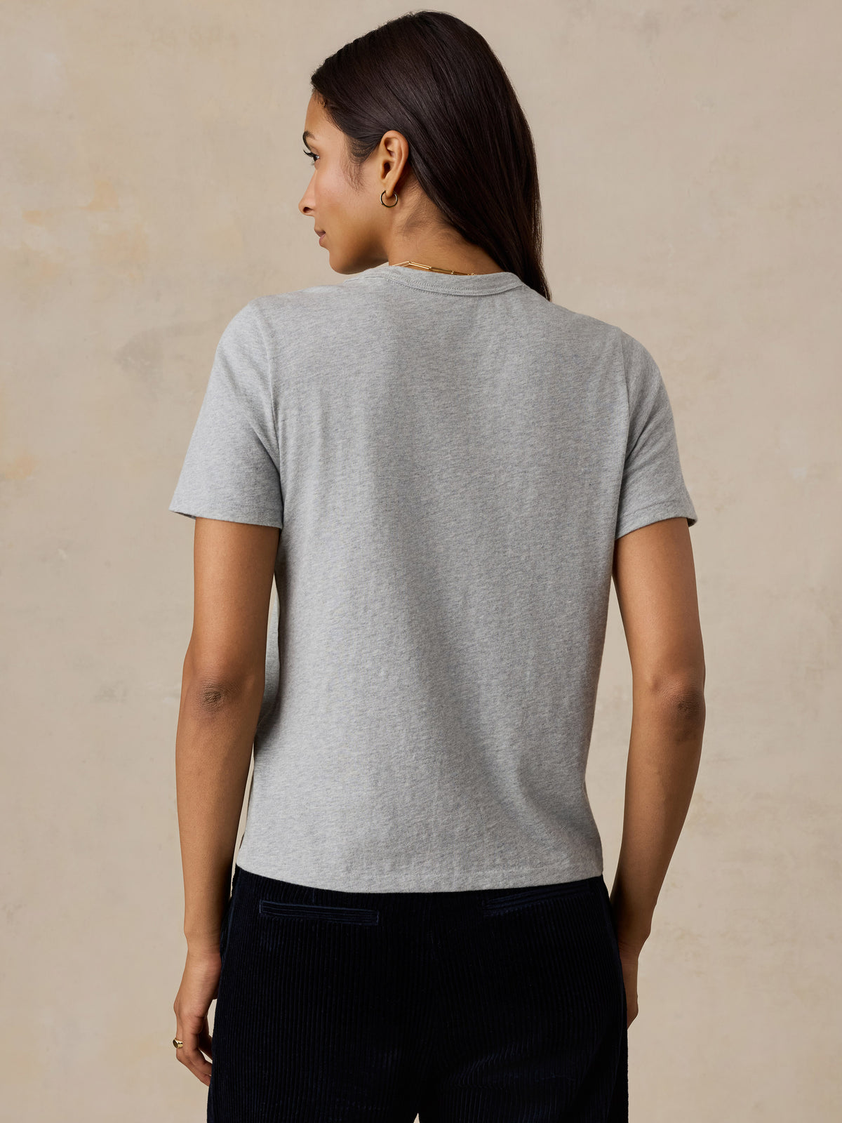 A woman viewed from behind wearing a grey Chicago Bulls tee, image 4 of 6