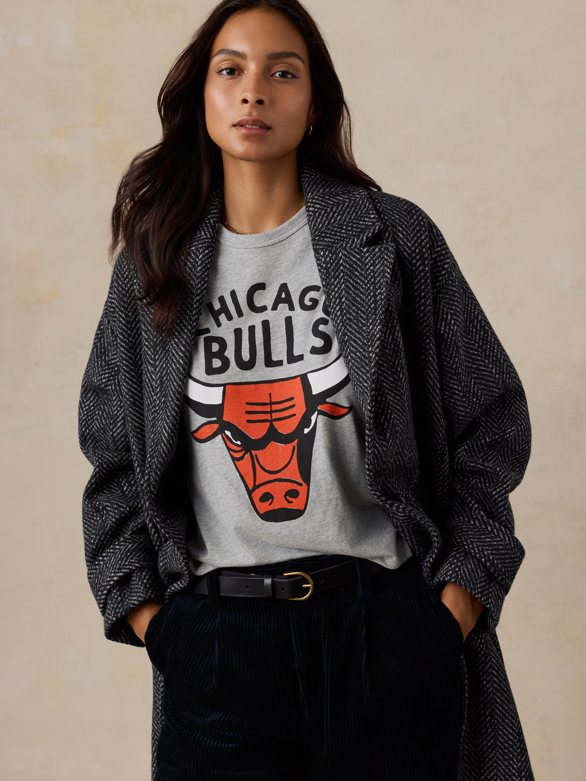 A woman wearing a grey Chicago Bulls tee and a jacket, image 3 of 6