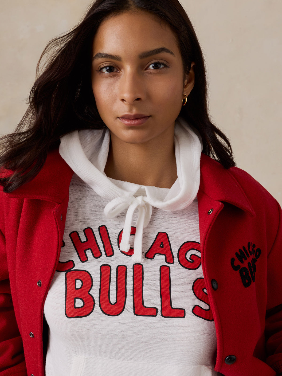 Close up of a woman wearing a white Chicago Bulls hoodie, image 4 of 5