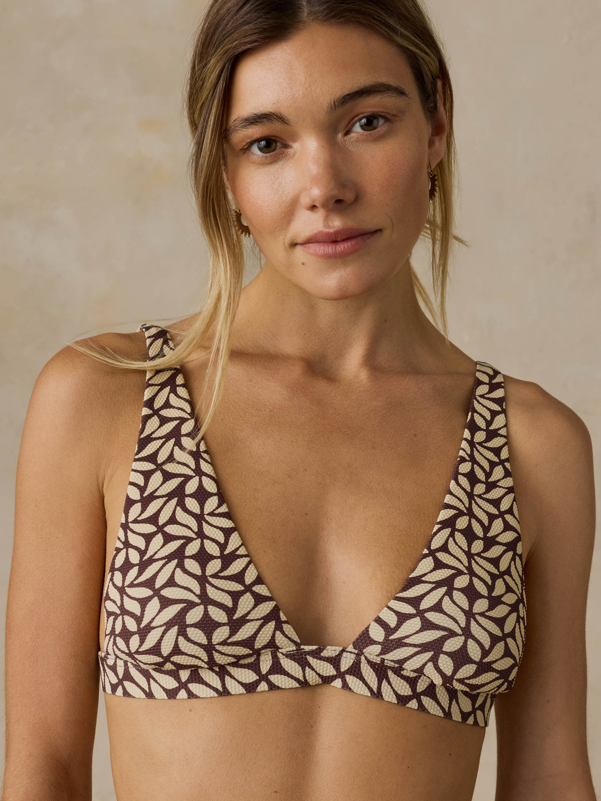 Woman wearing a brown printed swim suit  topagainst a beige background, image 2 of 6