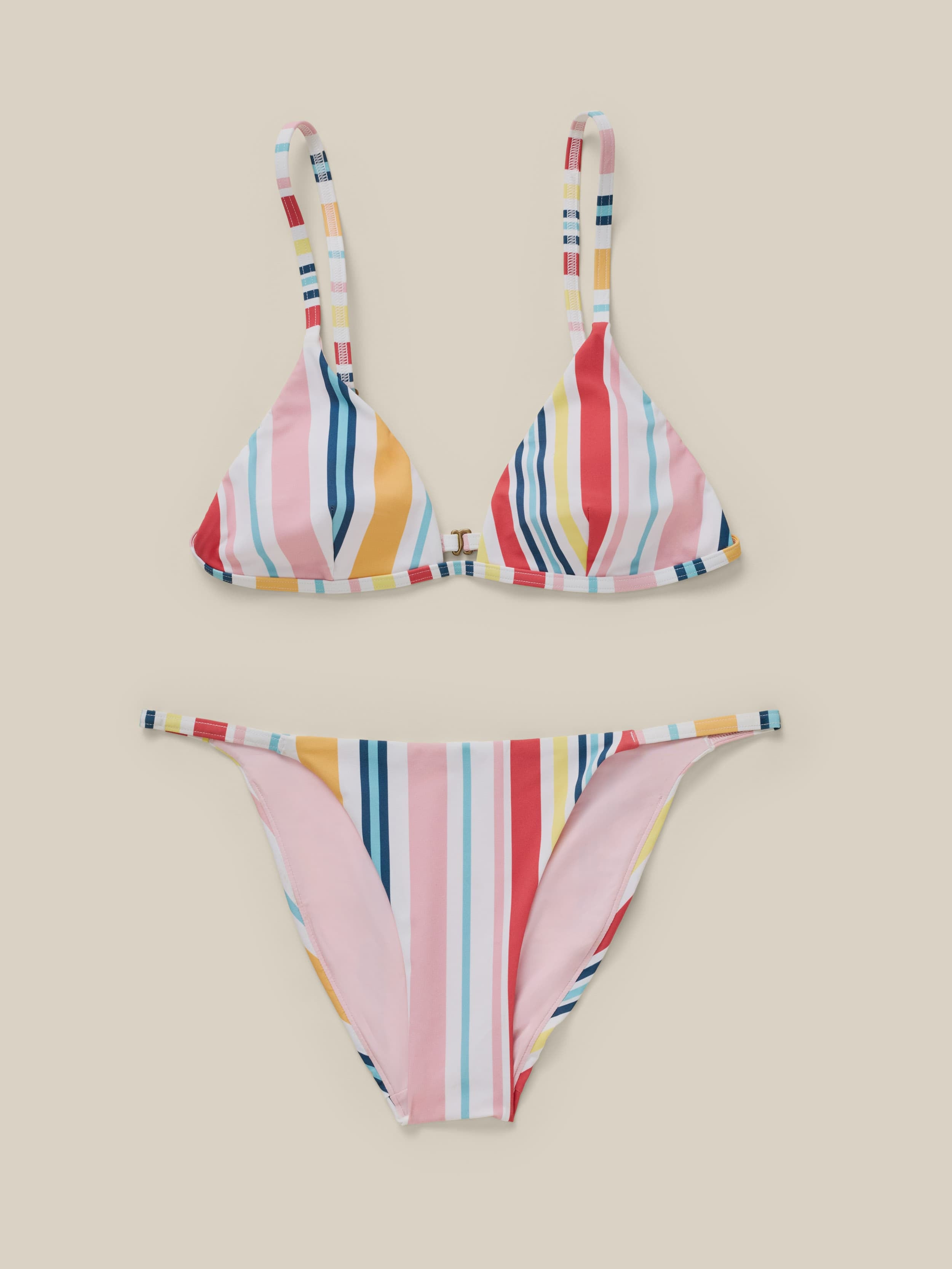 Multicolored striped bikini set on a beige background