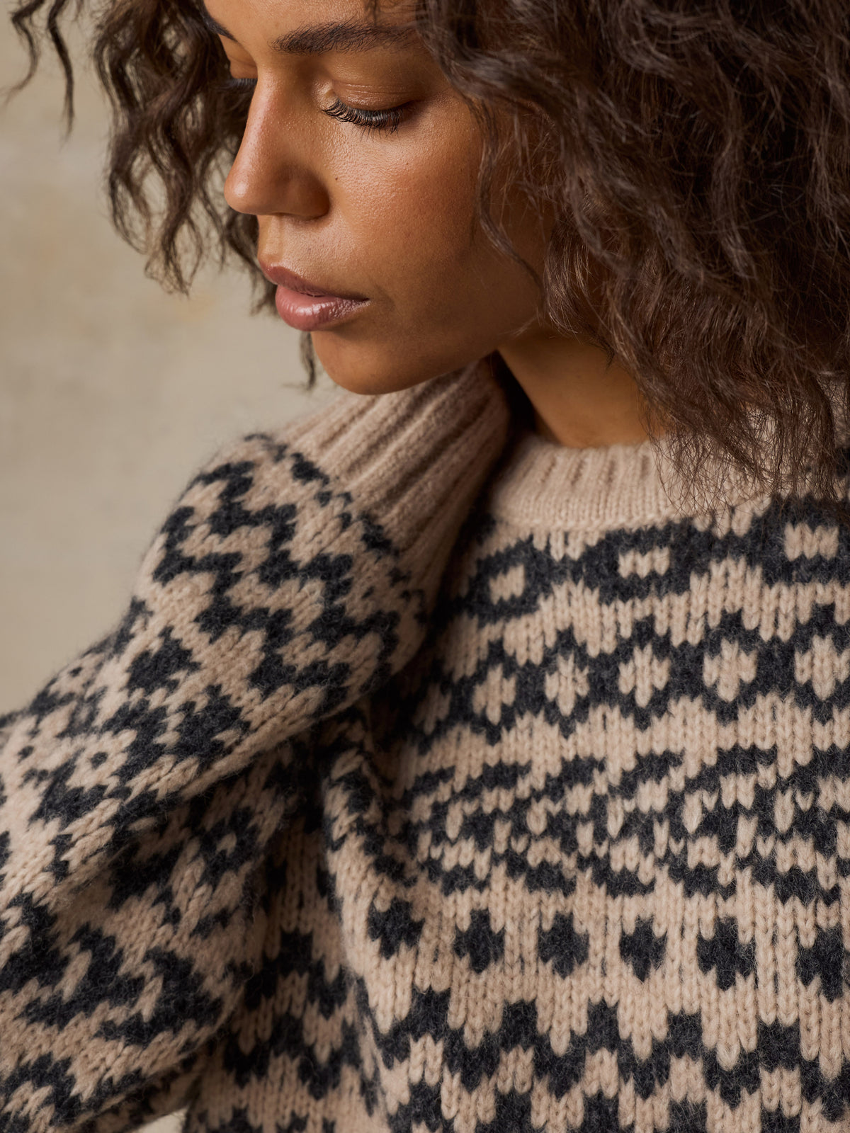 Close up of a woman wearing a beige sweater , image 6 of 7