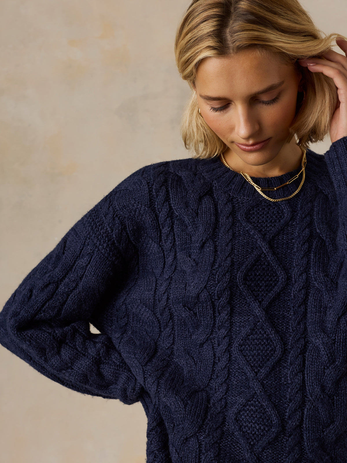 Close up of a woman wearing a blue sweater, image 2 of 5