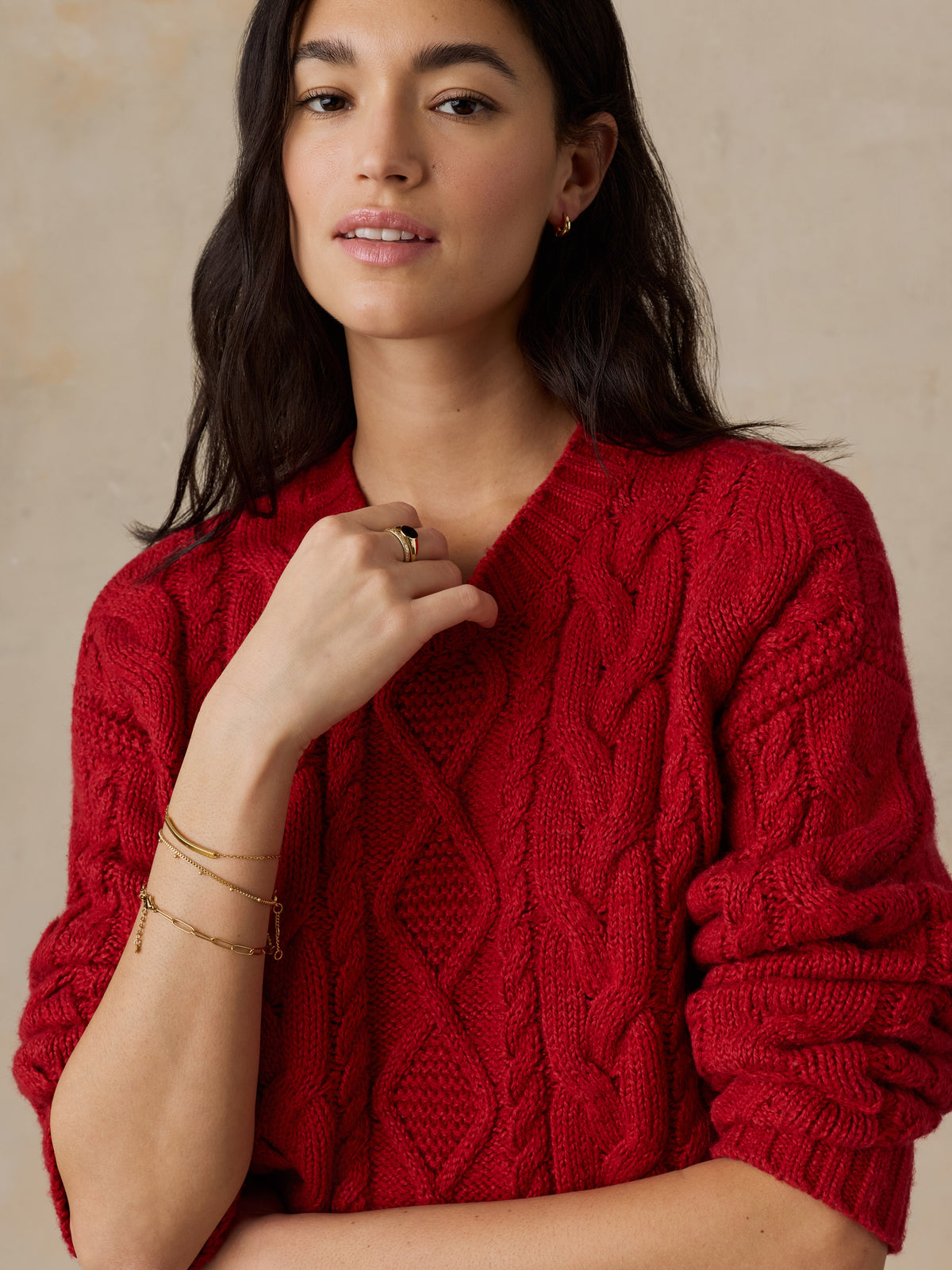 Close up of a woman wearing a red sweater, image 2 of 5