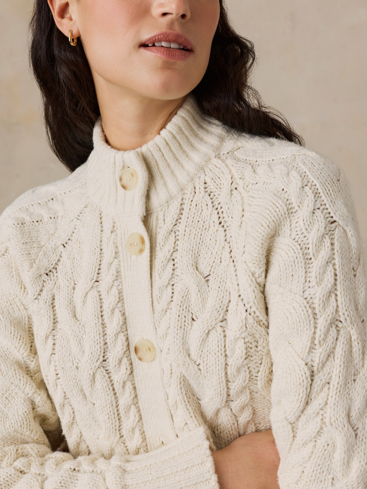 Close up of a woman wearing a cream cardigan , image 2 of 7