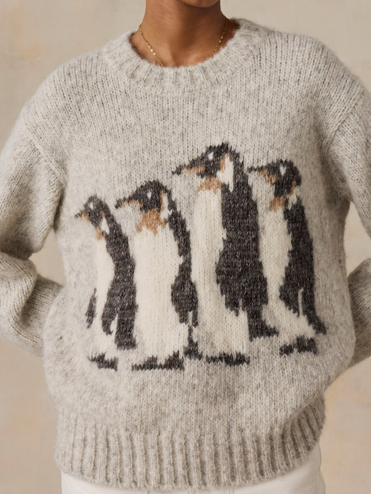 Close up of a woman wearing a grey Penguin sweater, image 3 of 5