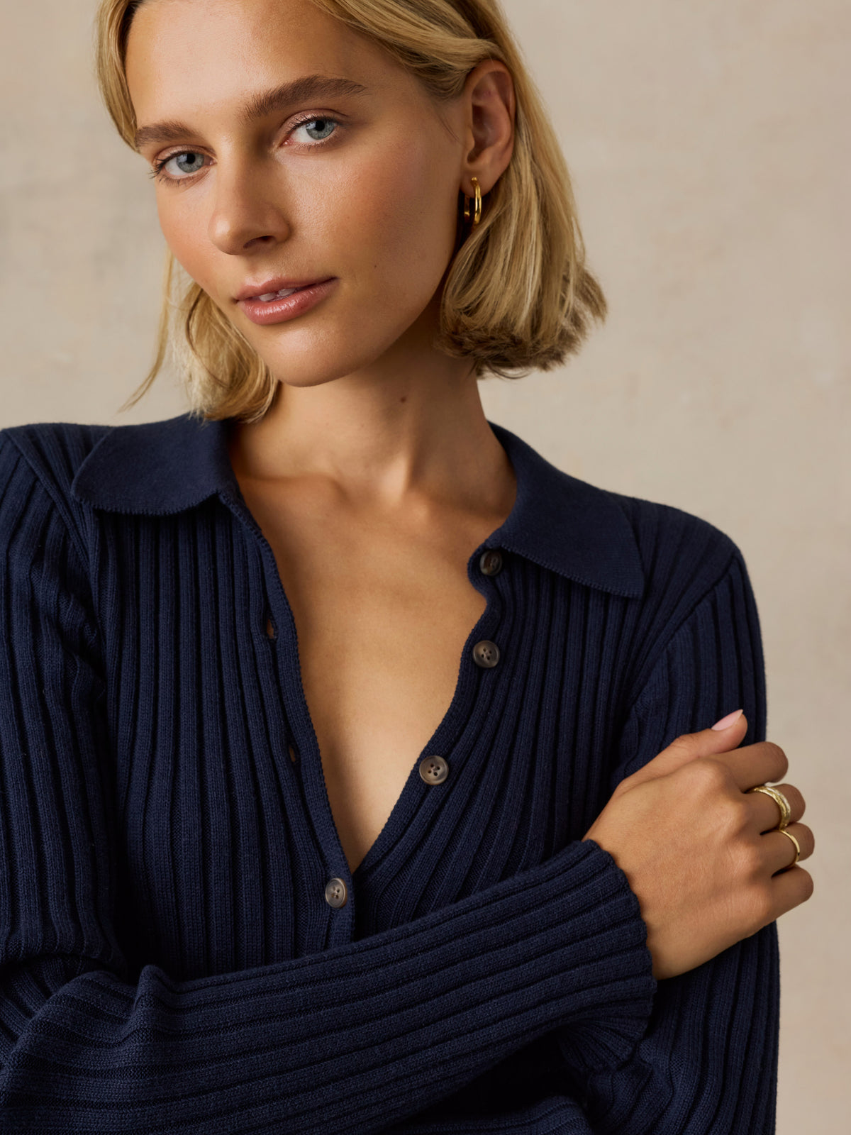 Close up of a woman wearing a blue cardigan, image 3 of 5