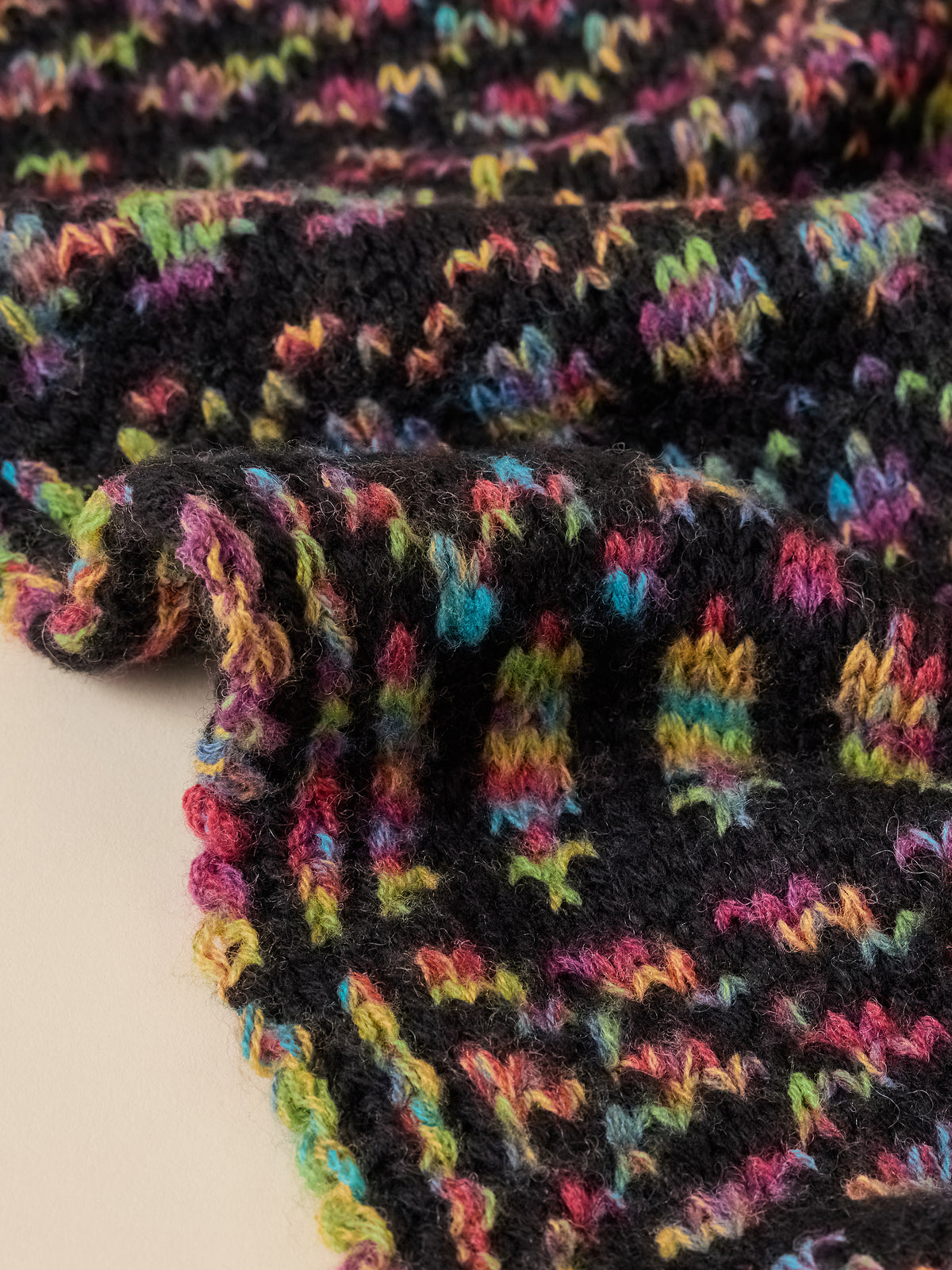 Close up of a multicolored knit scarf, image 3 of 3