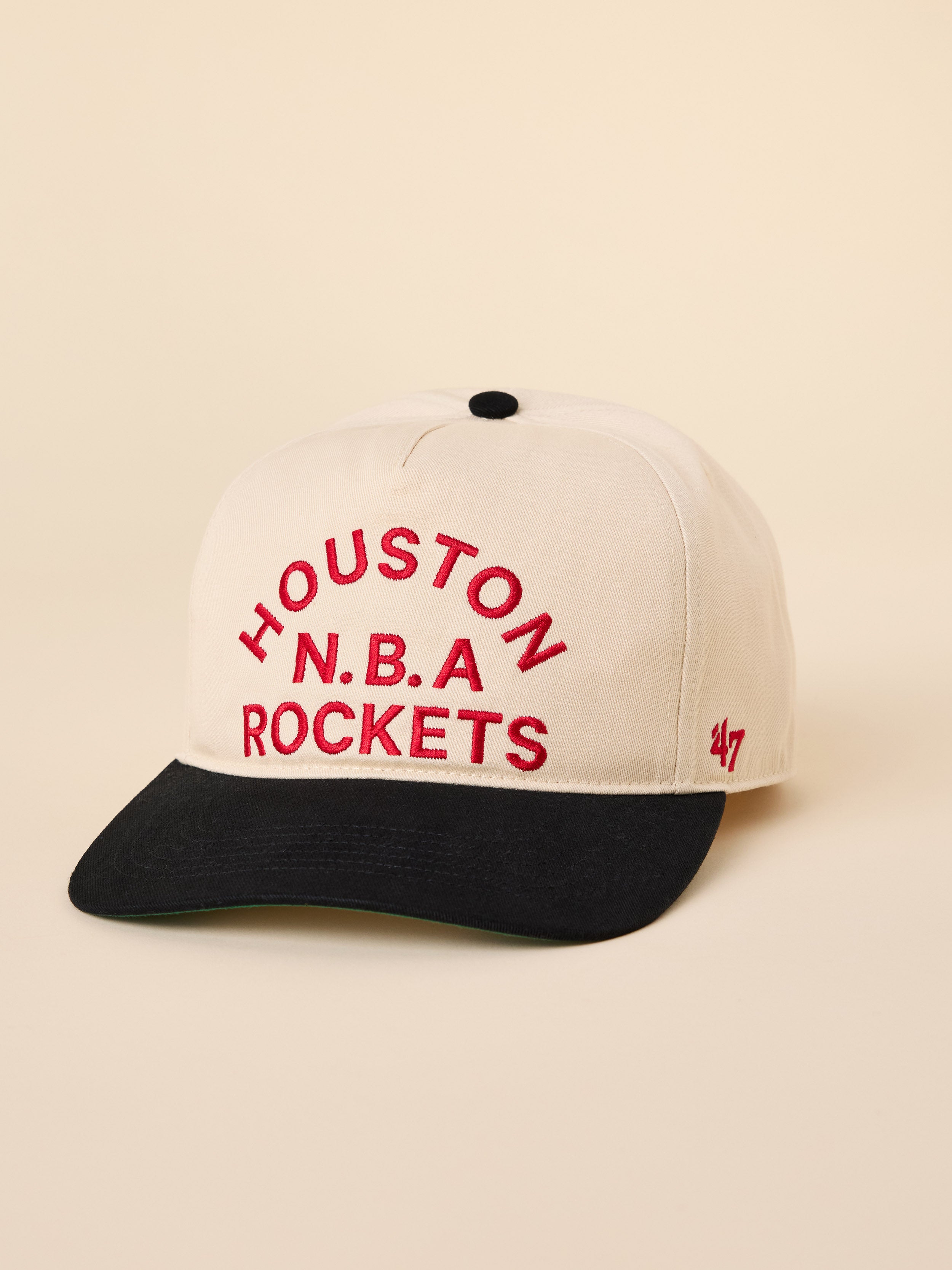 A beige and blue Houston Rockets hat