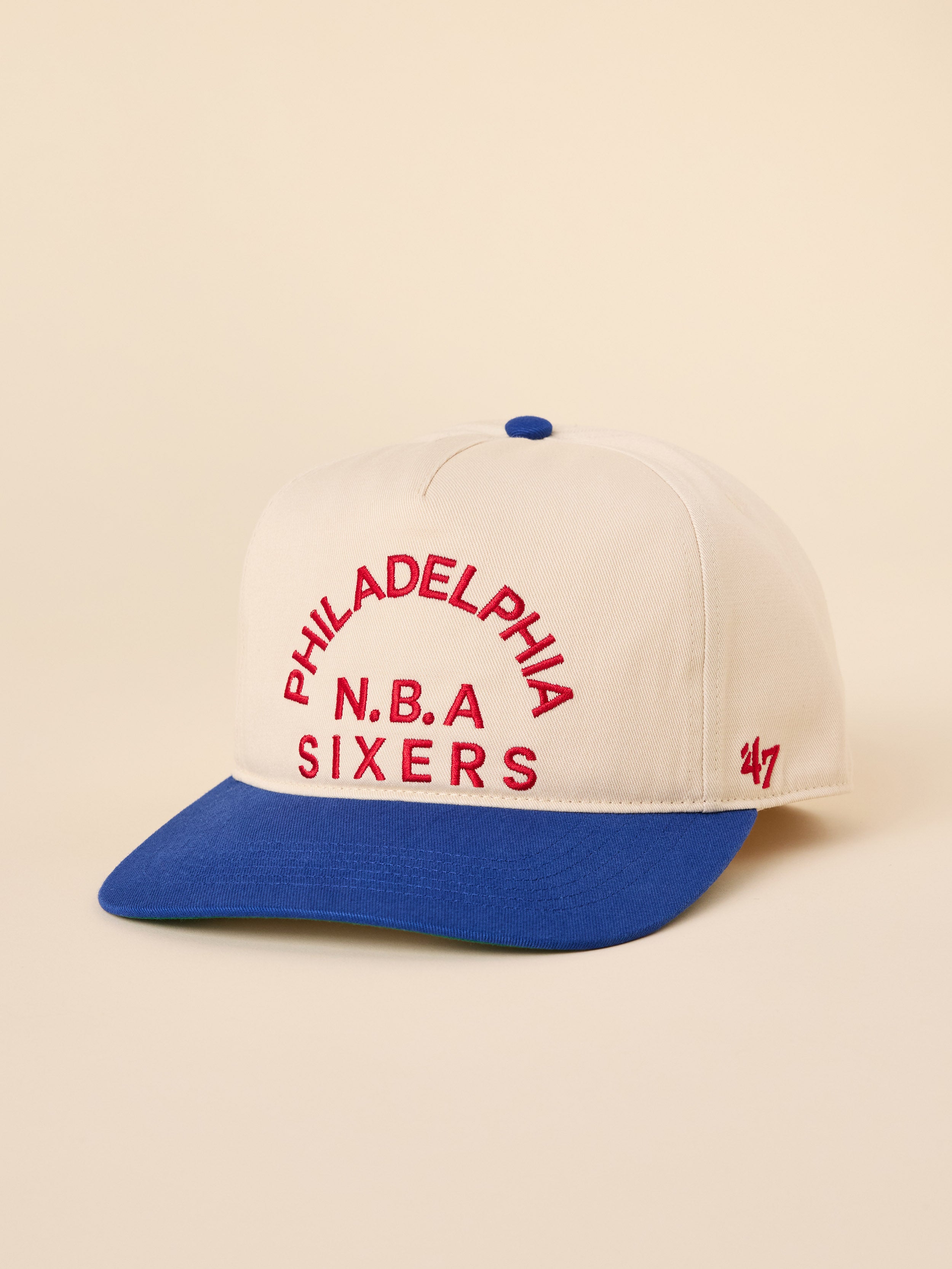 A beige and blue Philadelphia 76ers hat