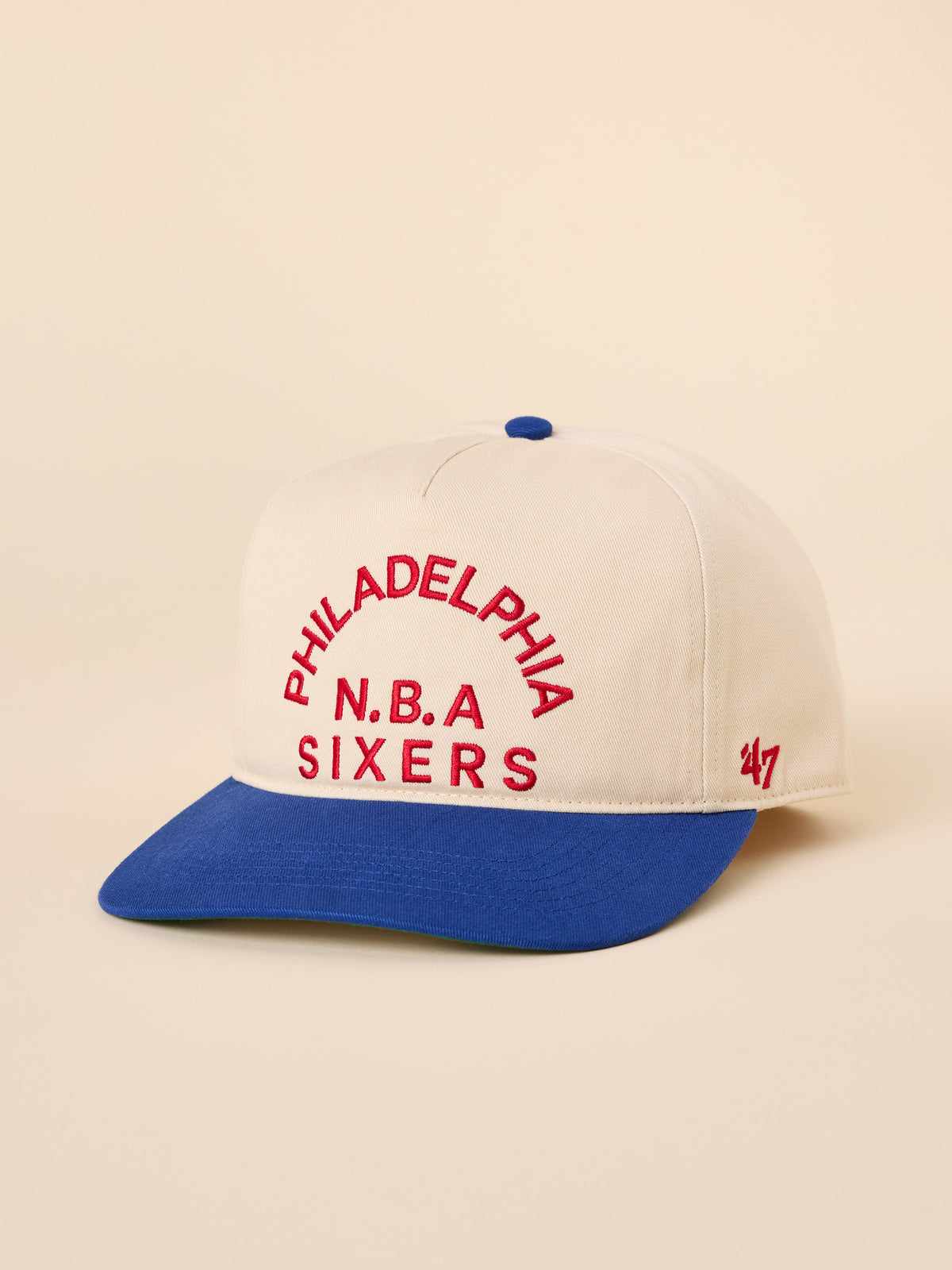 A beige and blue Philadelphia 76ers hat, image 1 of 3