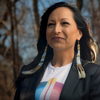 woman standing outside wearing long fringe earrrings